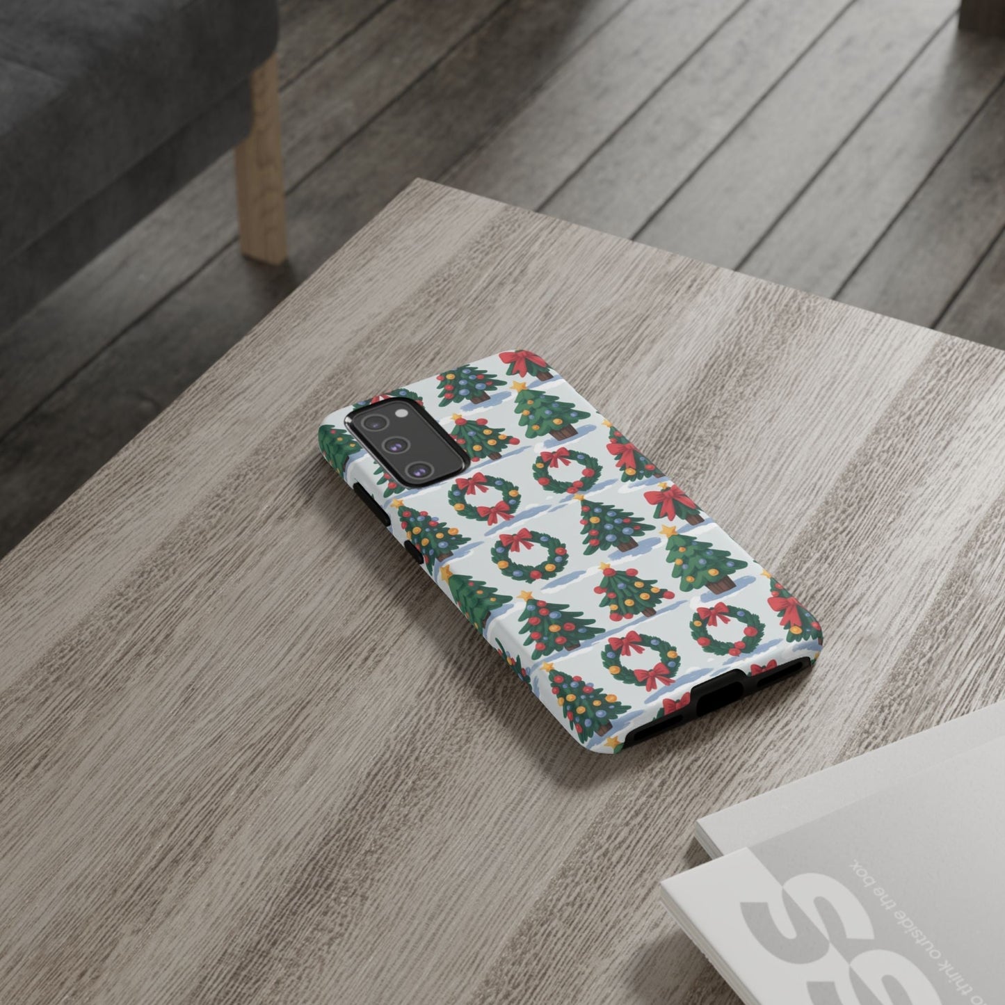 Samsung phone case with holiday wreath and tree pattern on wooden table, festive Christmas design, durable protective cover