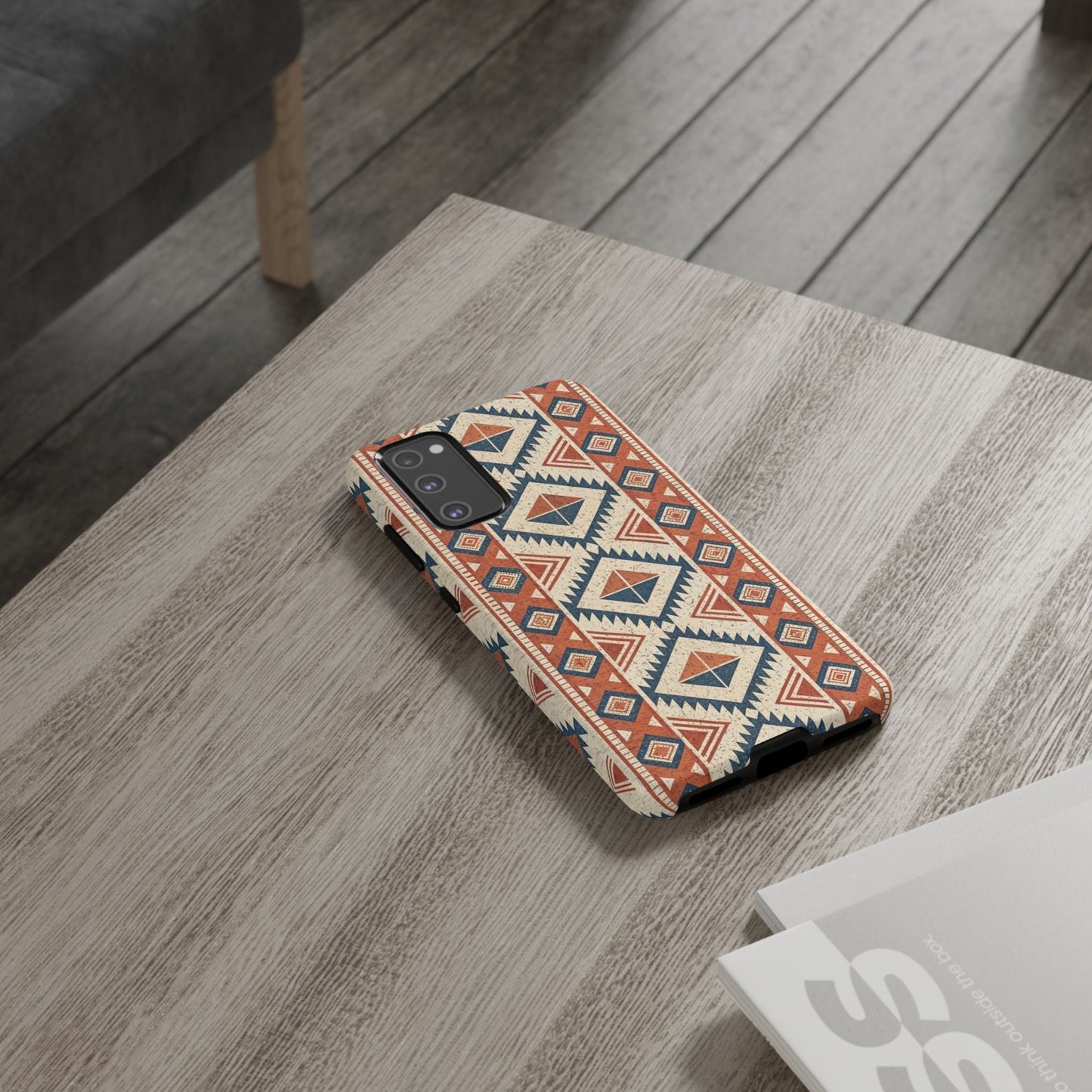 Samsung phone case with protective tribal design pattern on wooden table