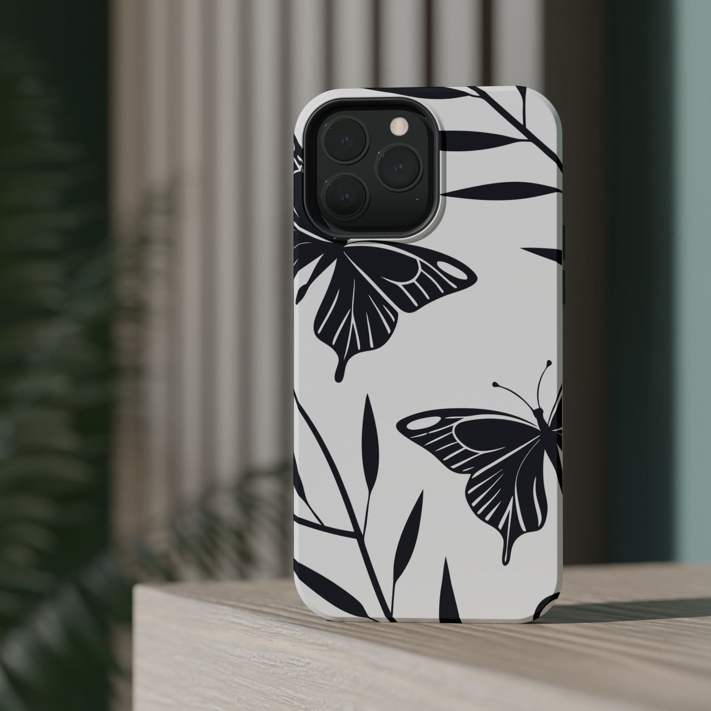 Black and white minimalist butterfly design iPhone case with dual-layer protection and MagSafe compatibility