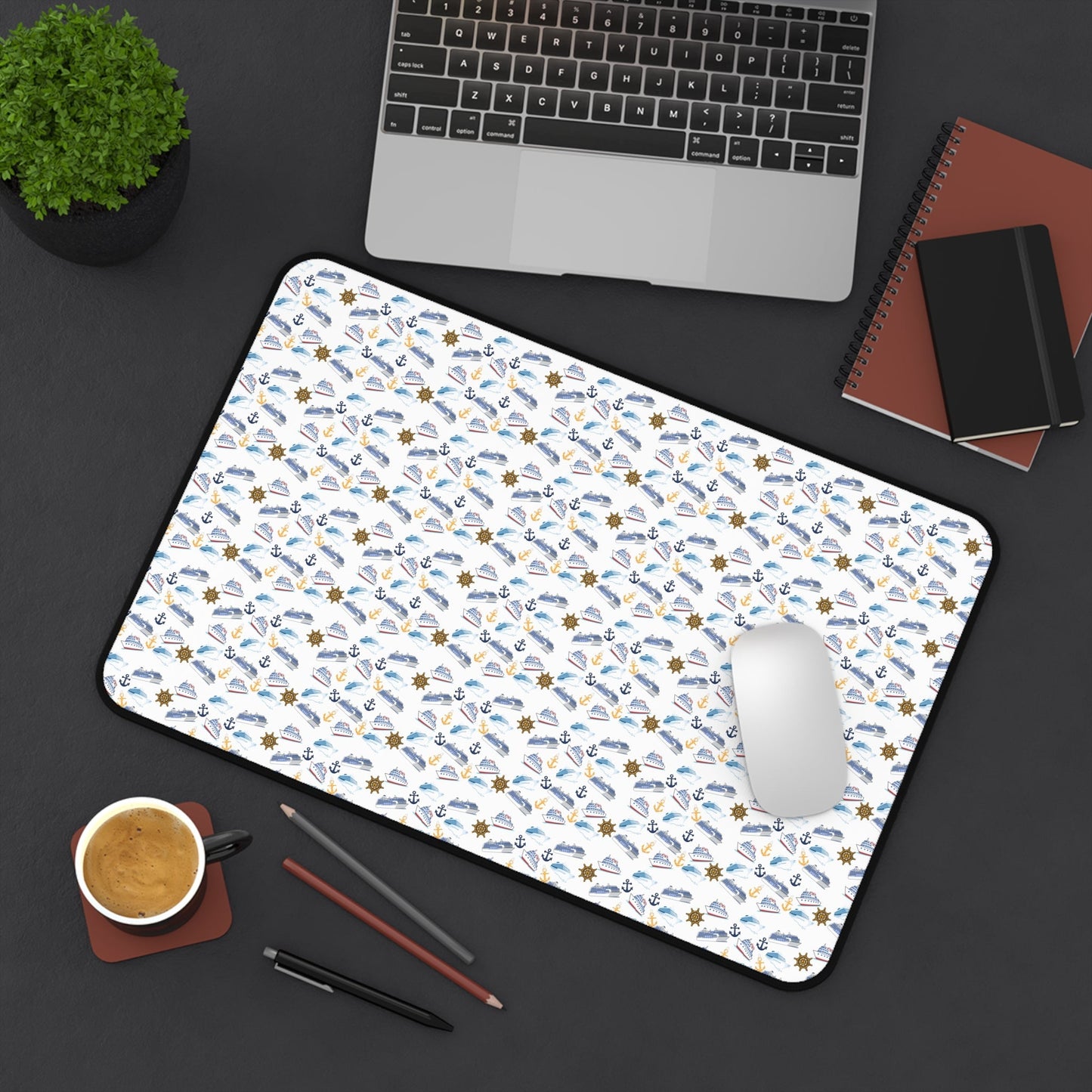 Cruise ship inspired desk mat with nautical theme, vibrant colors, and hemmed edges on a workspace with laptop, mouse, coffee, and stationery.