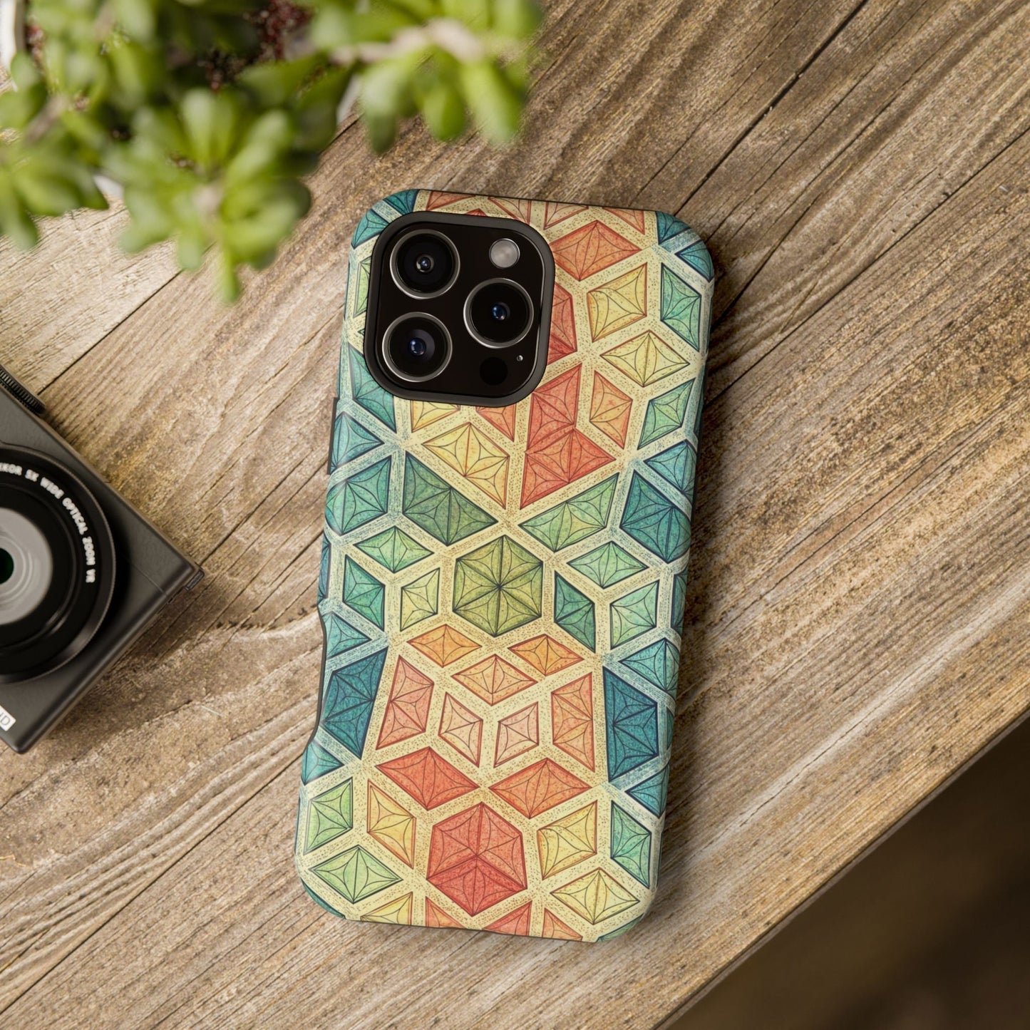 Colorful fractal geometric pattern iPhone magnetic tough case on wooden surface with camera nearby