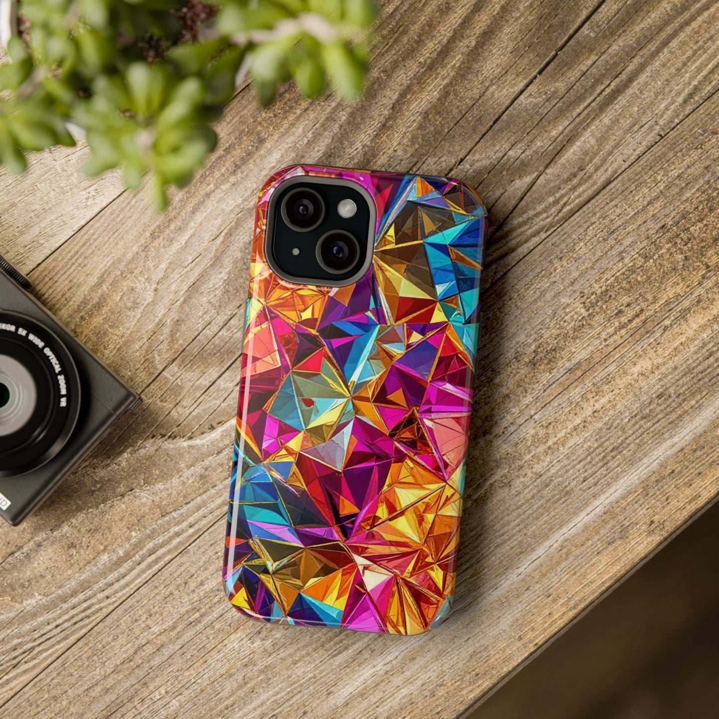 Colorful geometric rainbow foil iPhone tough case with glossy finish and MagSafe compatibility on wooden surface