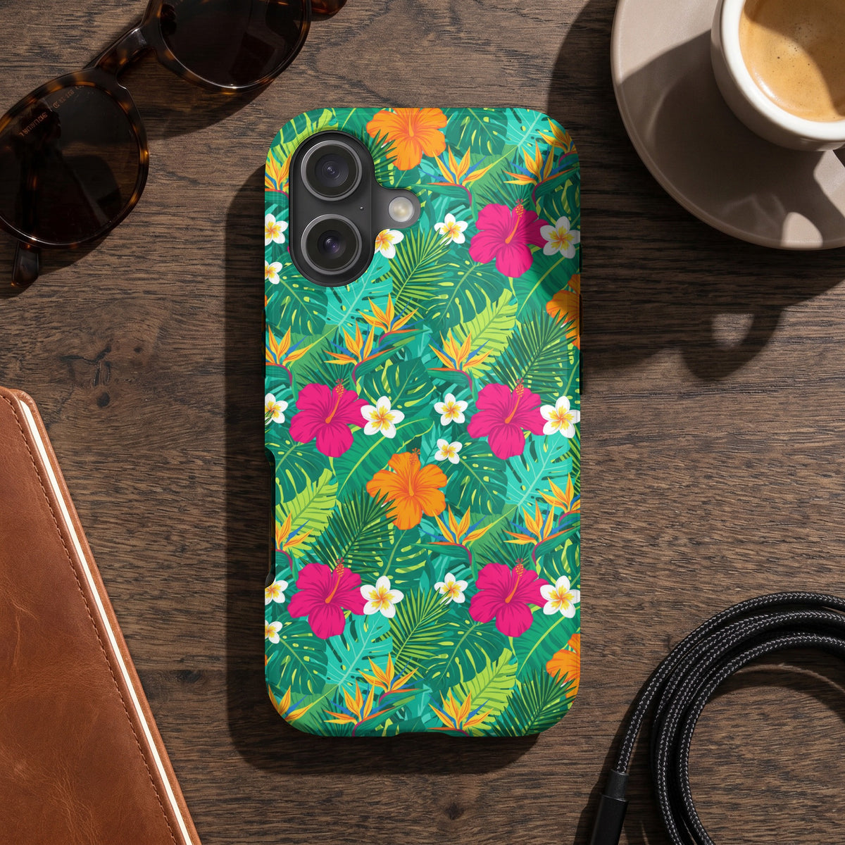 Phone case with a colorful tropical floral and leaf pattern.