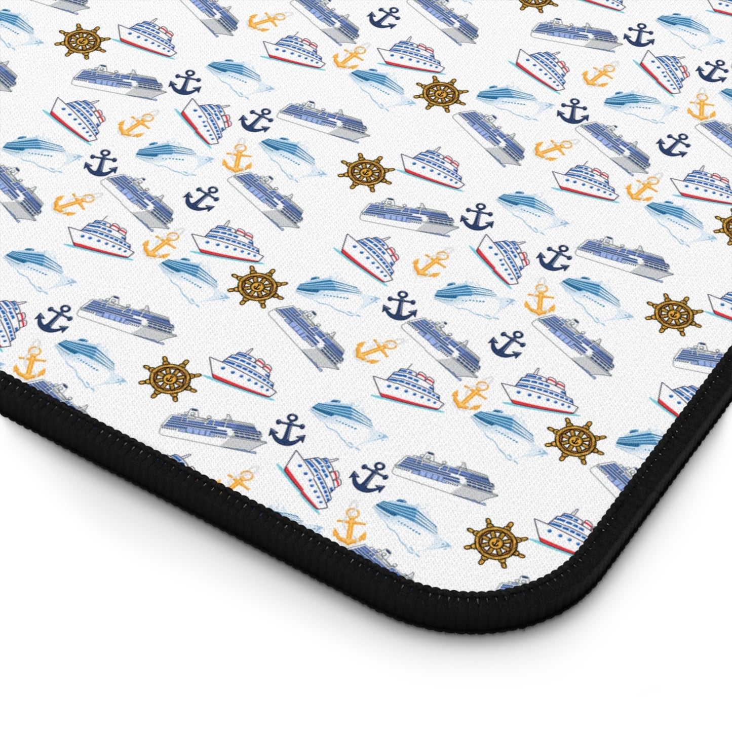 Cruise ship inspired desk mat with nautical-themed icons and black hemmed edges on white neoprene surface