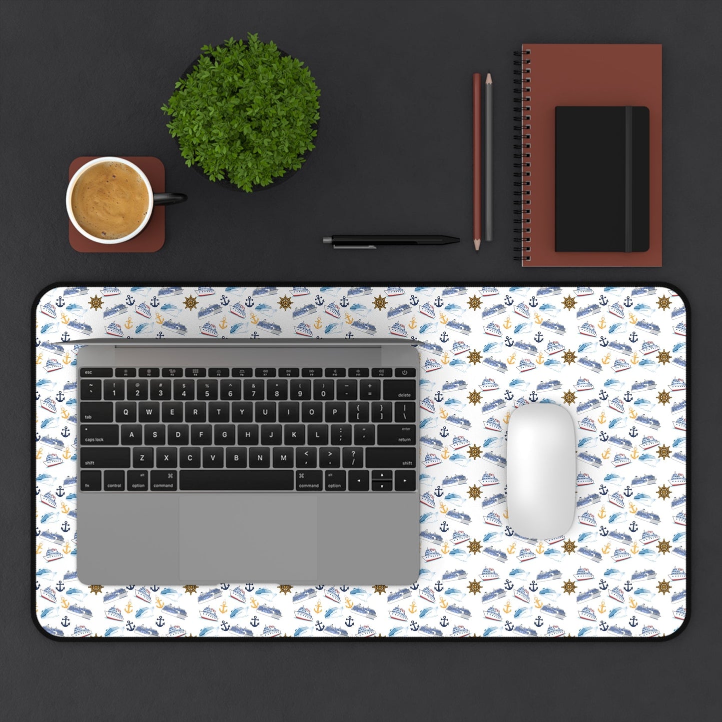Cruise ship inspired desk mat with nautical pattern, laptop, mouse, coffee cup, and office supplies on black surface