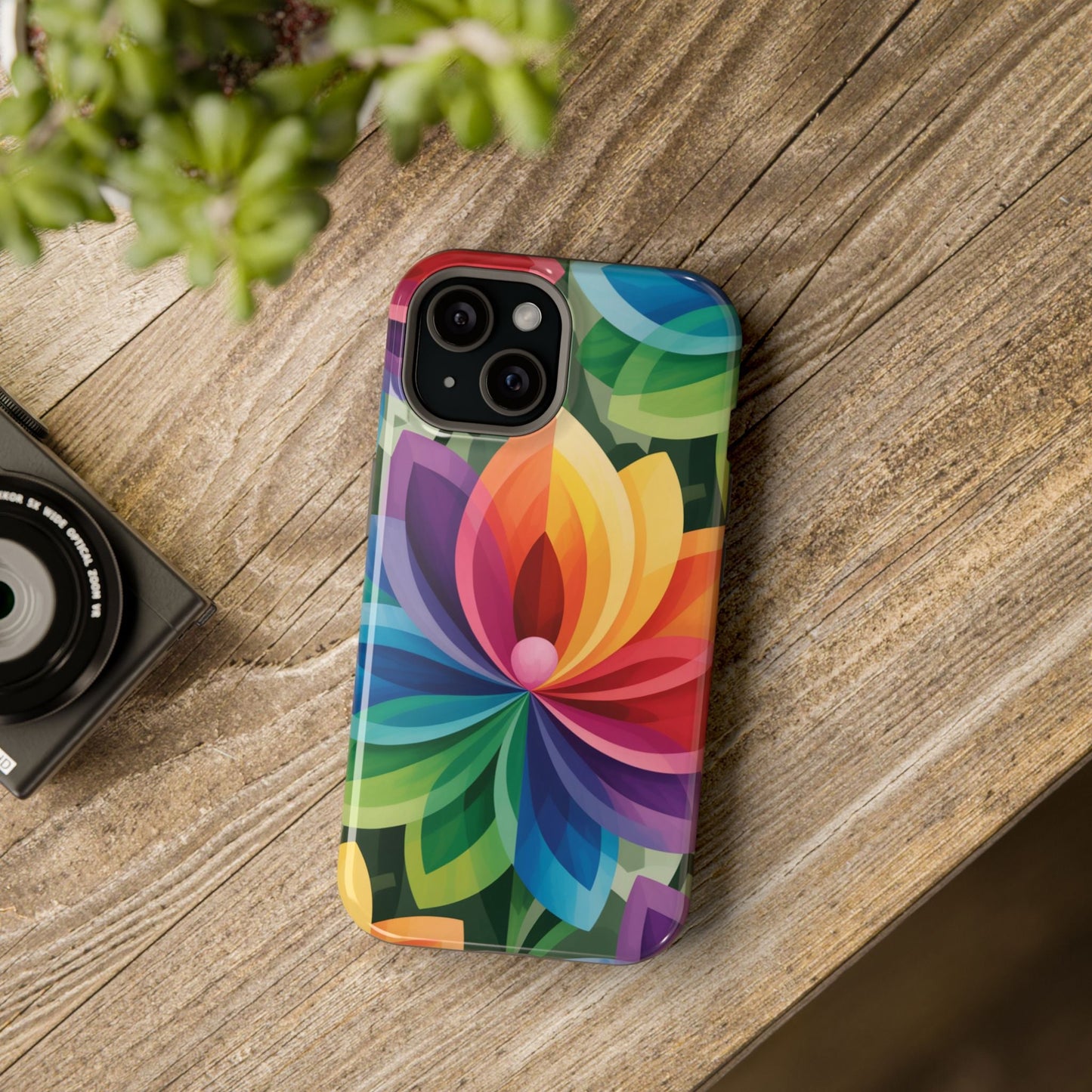 Rainbow Flower iPhone Case with vibrant multicolor flower design and MagSafe compatibility on wooden surface.