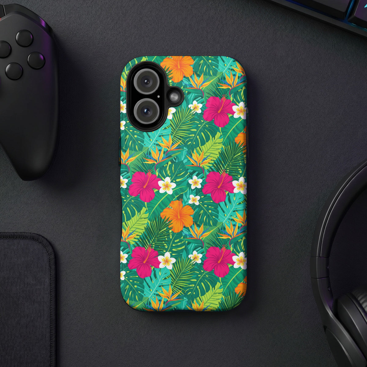 Phone case with tropical floral and leaf pattern, featuring hibiscus and bird of paradise flowers.