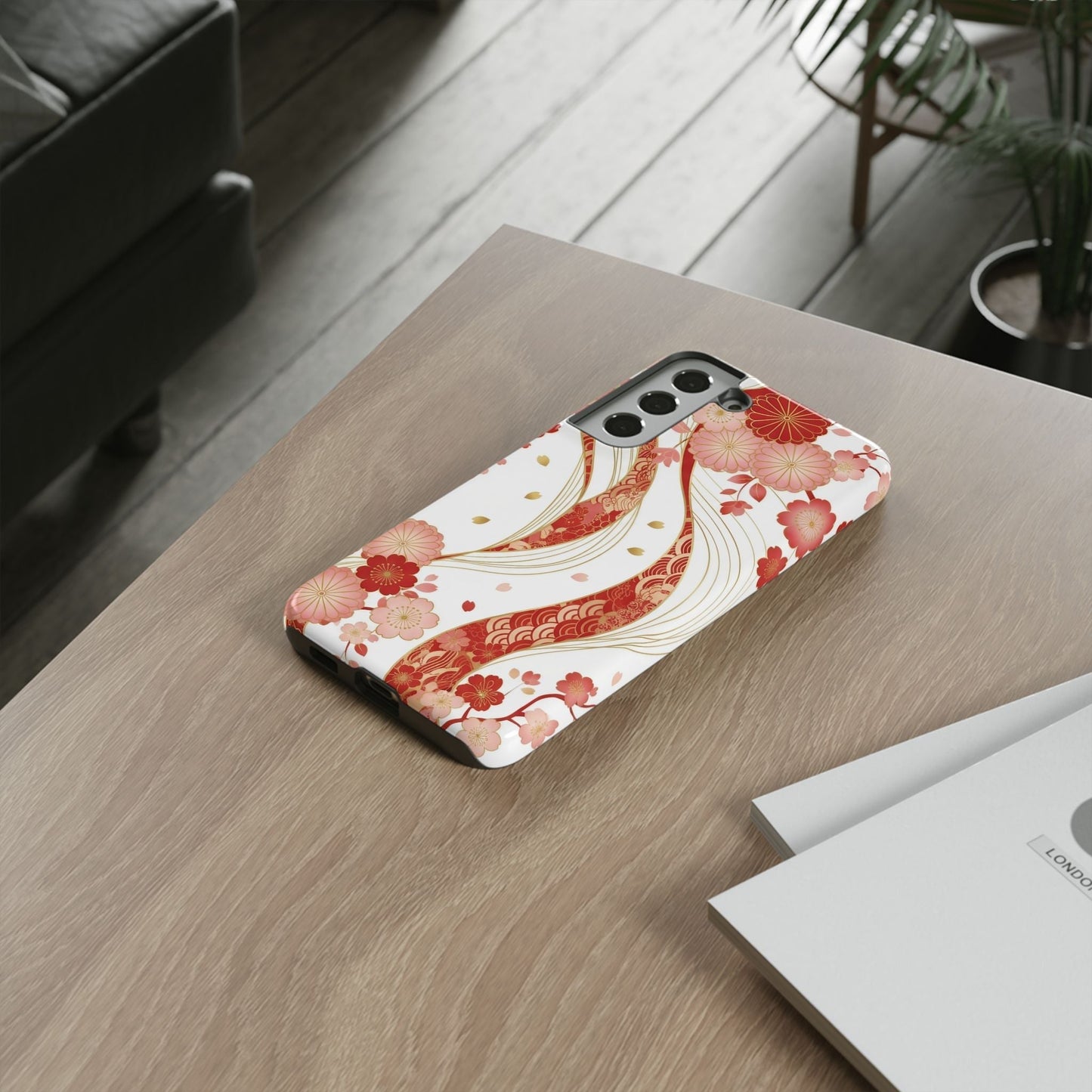 Samsung phone with elegant red golden flower phone case featuring intricate floral 3D wrap design on wooden table