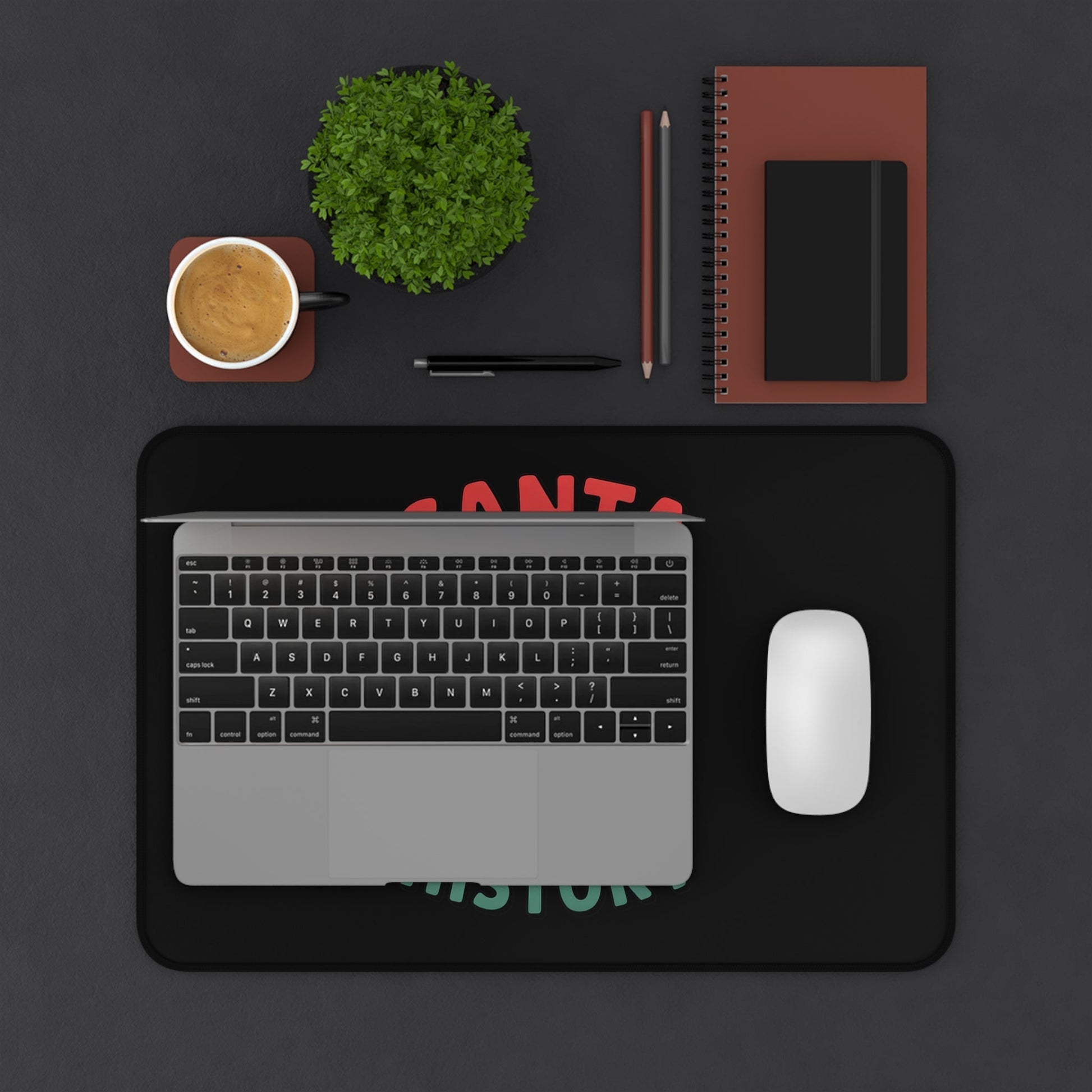 Funny Santa desk mat with humorous Christmas design under laptop and mouse on black desk setup