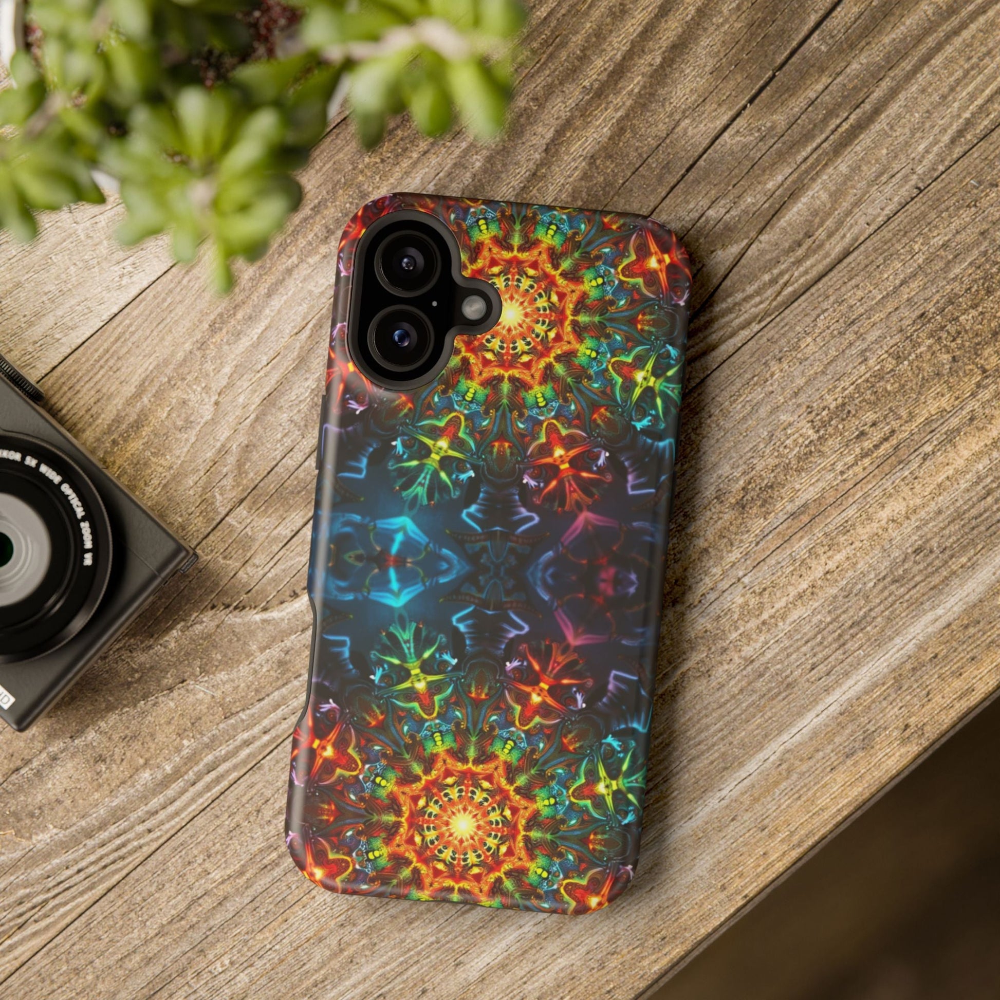 iPhone case with vibrant abstract kaleidoscope design and dual-layer protection on wooden surface