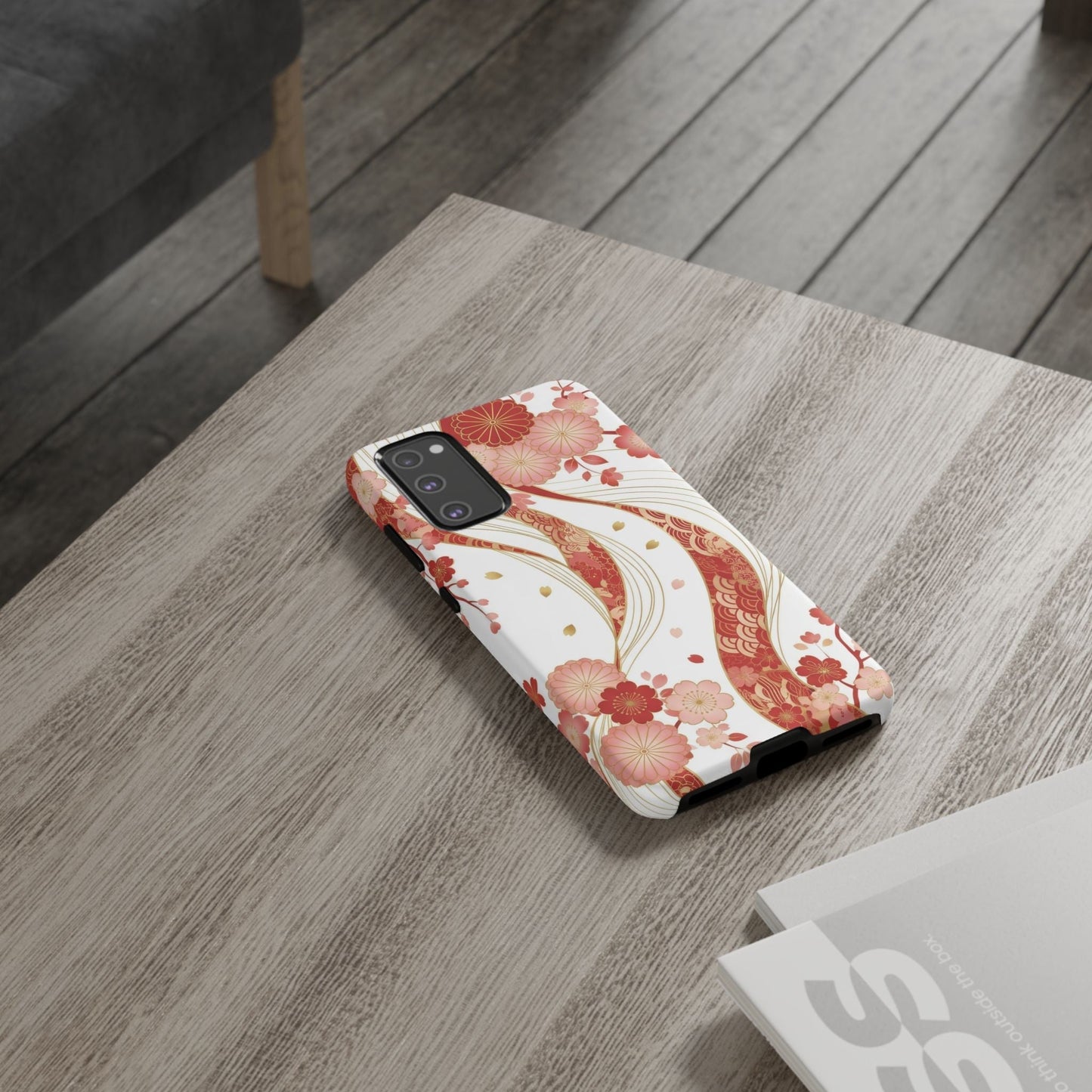 Samsung phone with red golden flower phone case featuring intricate floral 3D design on wooden table