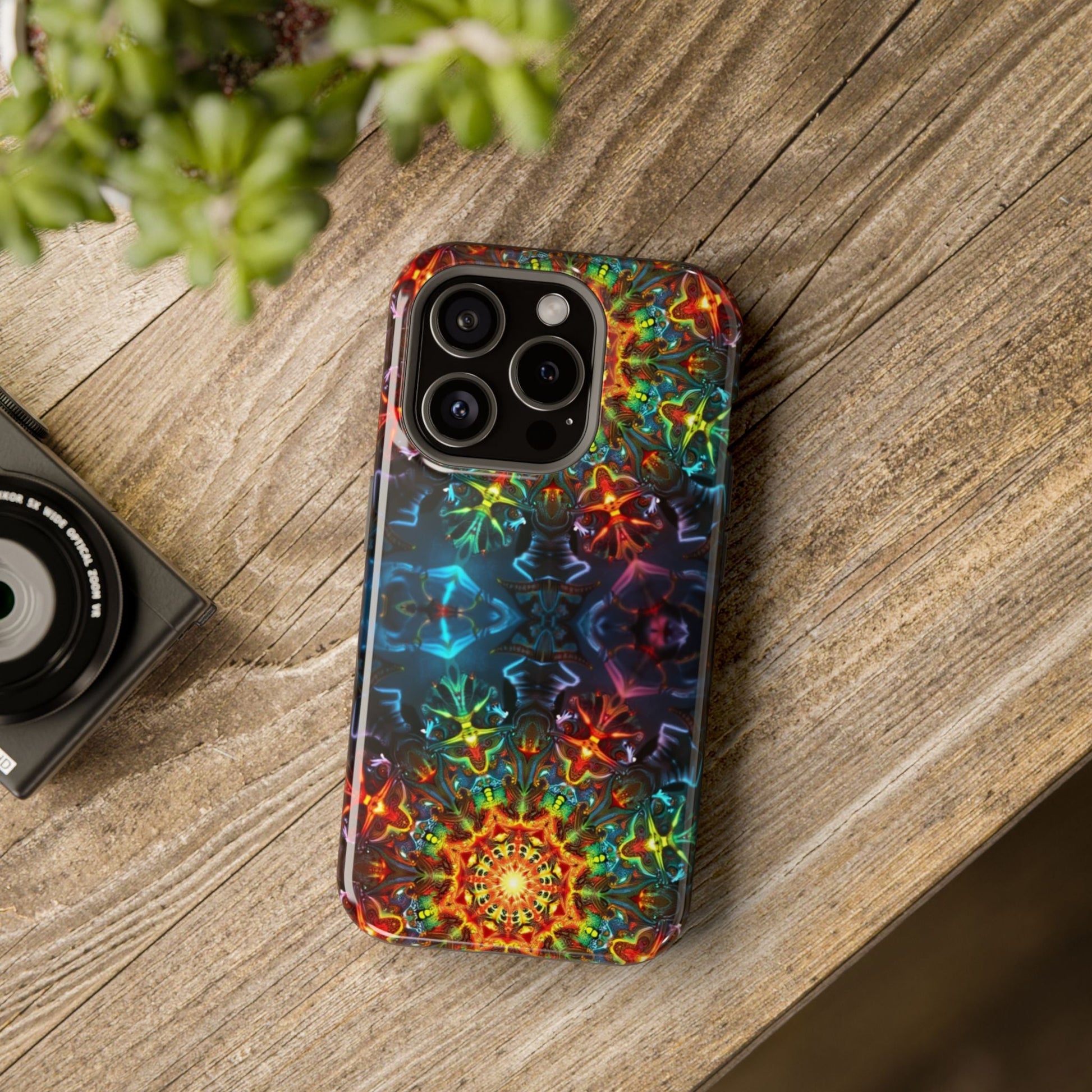 iPhone case with vibrant abstract kaleidoscope design on wooden surface