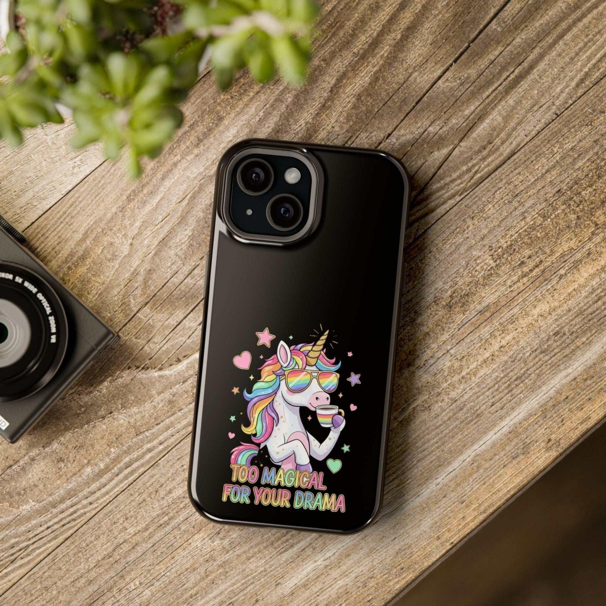 Durable black iPhone case with colorful unicorn and "Too Magical for Your Drama" text, impact-resistant polycarbonate protection
