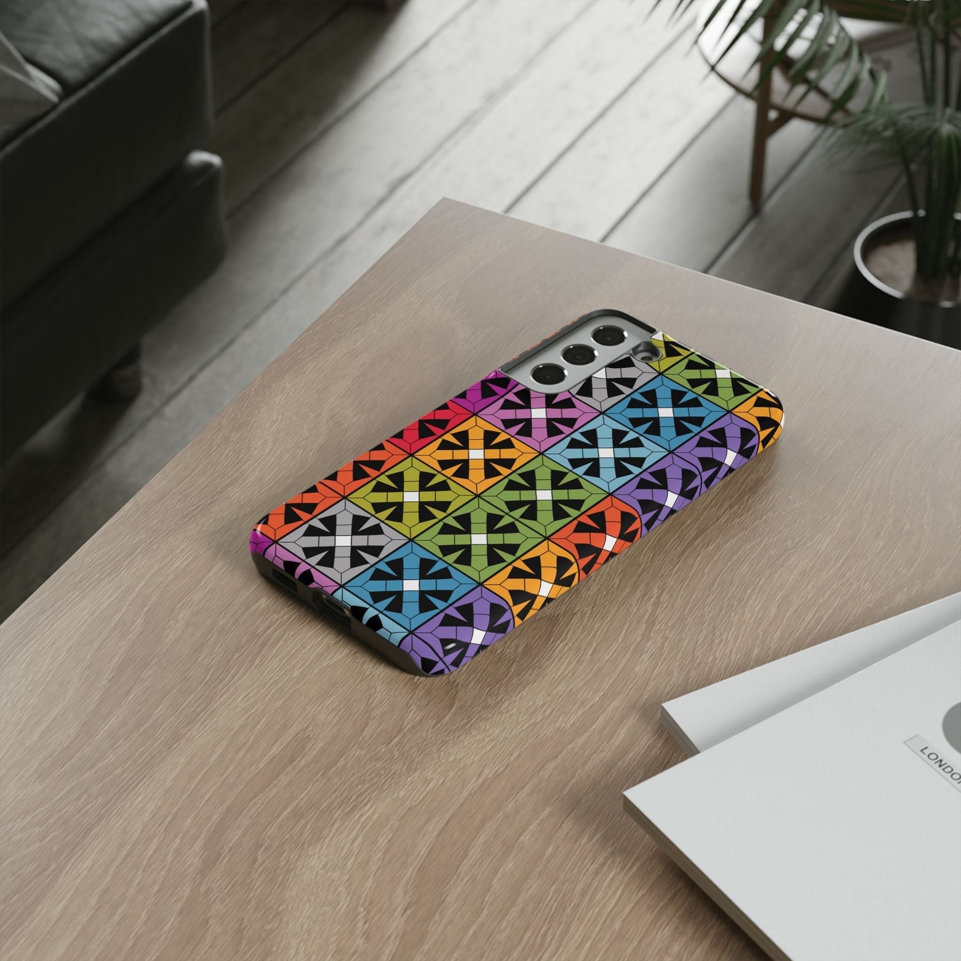 Samsung phone case with rainbow abstract square design and vibrant colors on wooden table
