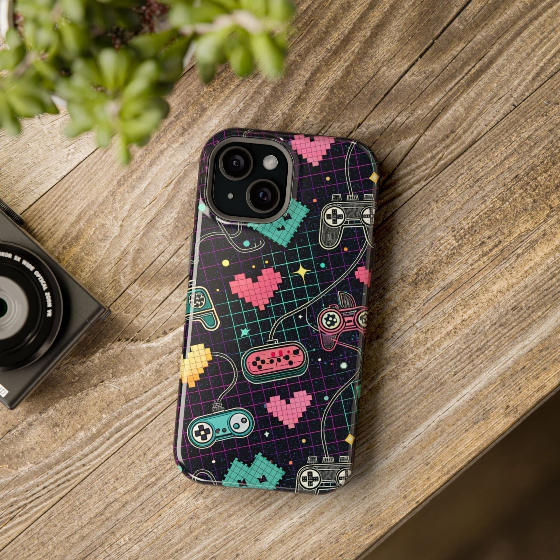Retro Gamer Inspired durable dual-layer iPhone case with MagSafe, featuring colorful pixelated hearts and classic game controllers on a dark grid background.