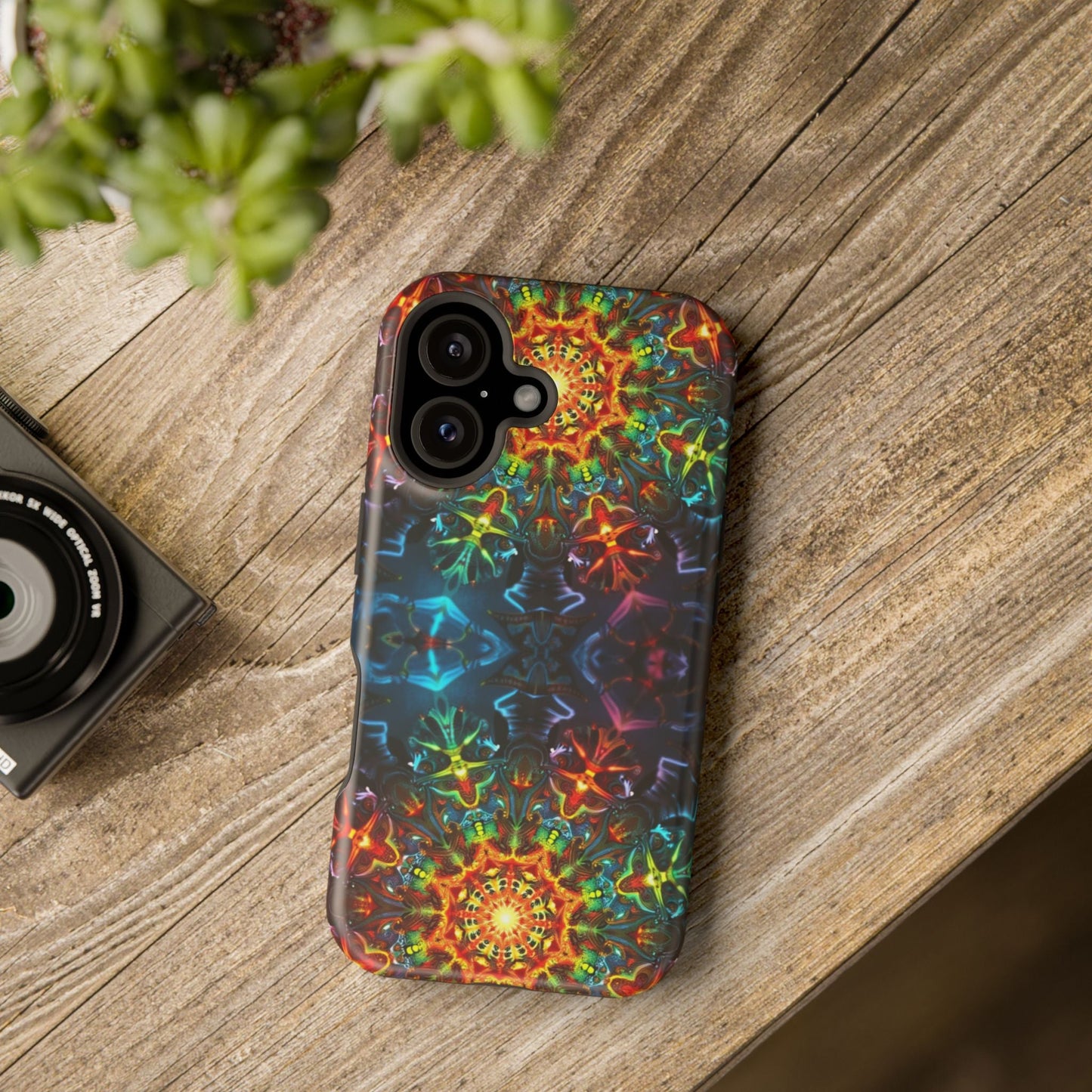 Colorful abstract kaleidoscope design iPhone case with dual-layer protection on wooden surface