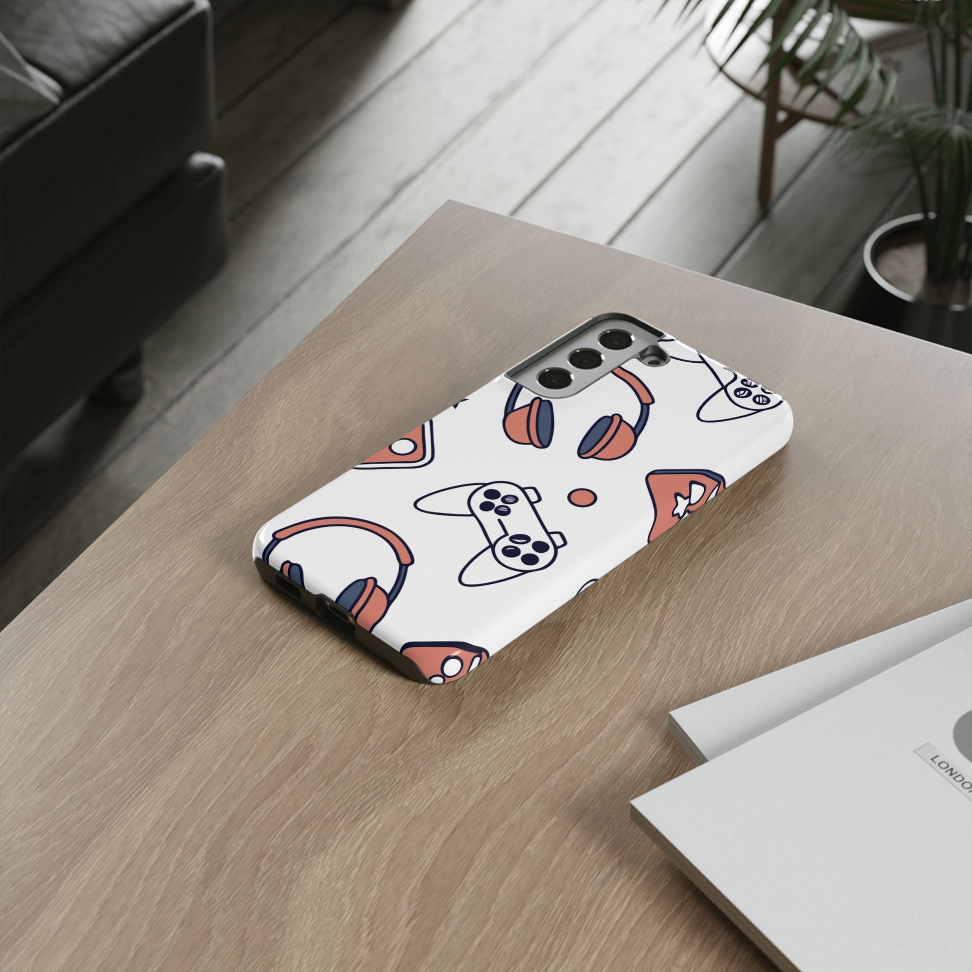 Samsung phone case with gamer design featuring controllers and headphones, durable and impact-resistant protection