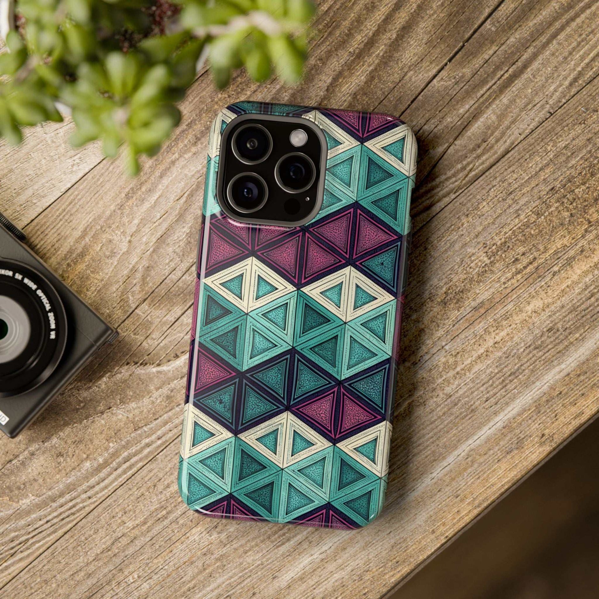 Purple and teal abstract geometric patterned iPhone tough case with MagSafe compatibility on wooden surface