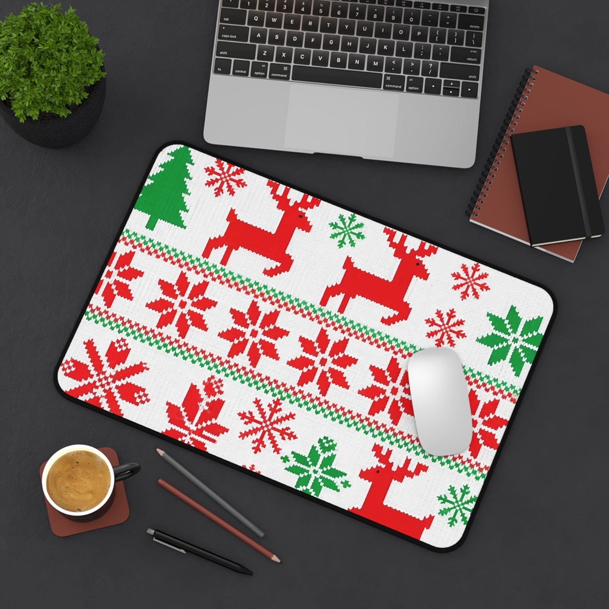 Festive ugly sweater inspired desk mat with red reindeer and green Christmas tree pattern on office desk
