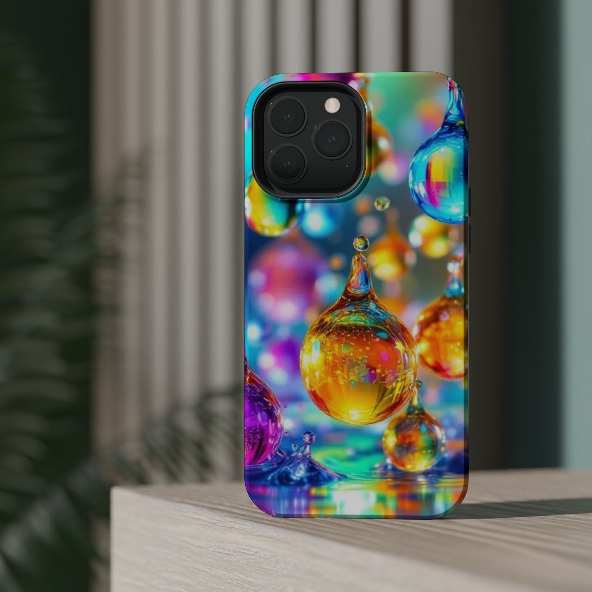 Colorful iPhone tough case featuring a vibrant golden raindrop design with a glossy finish and MagSafe compatibility.