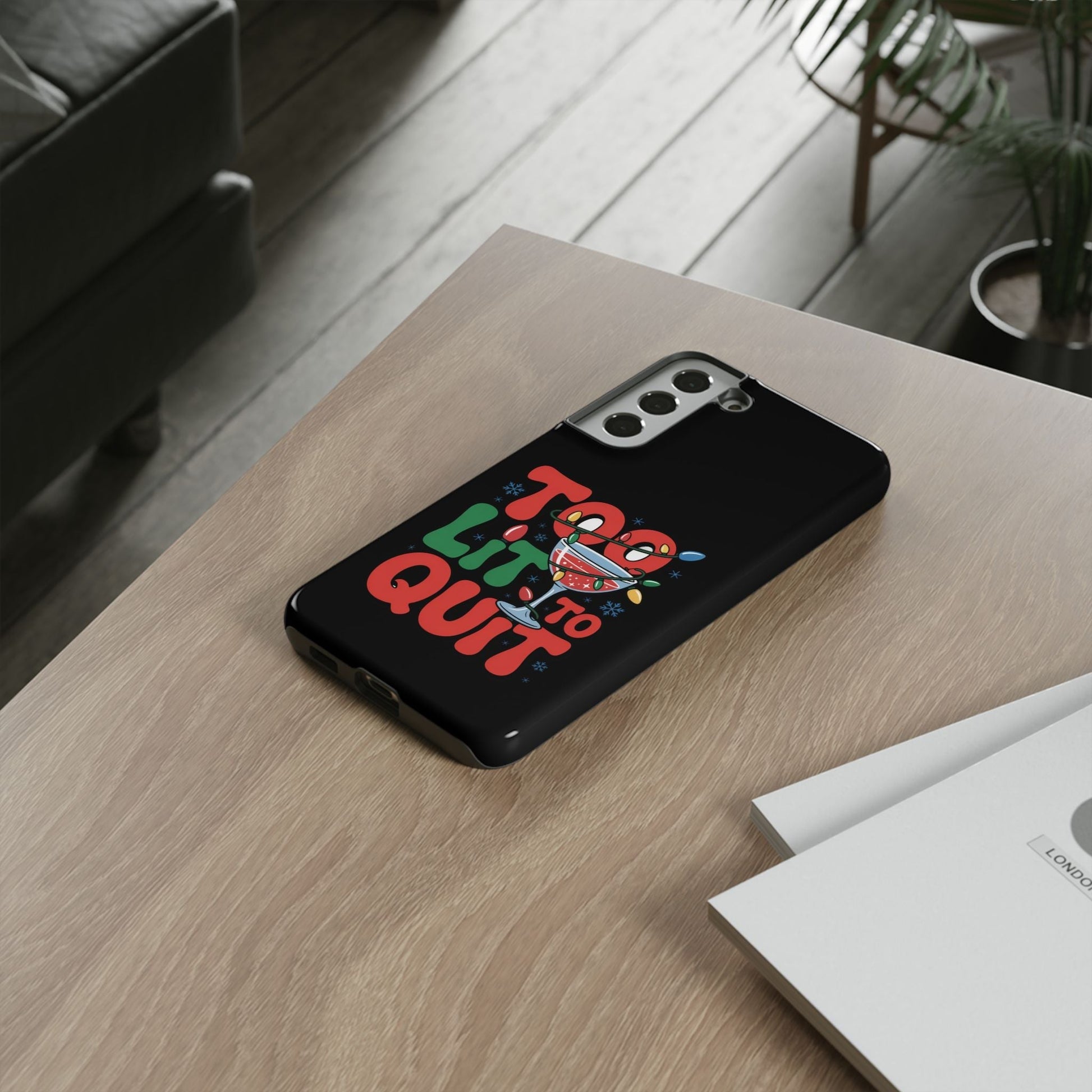 Holiday themed Samsung phone case with "Too Lit to Quit" festive design on black background
