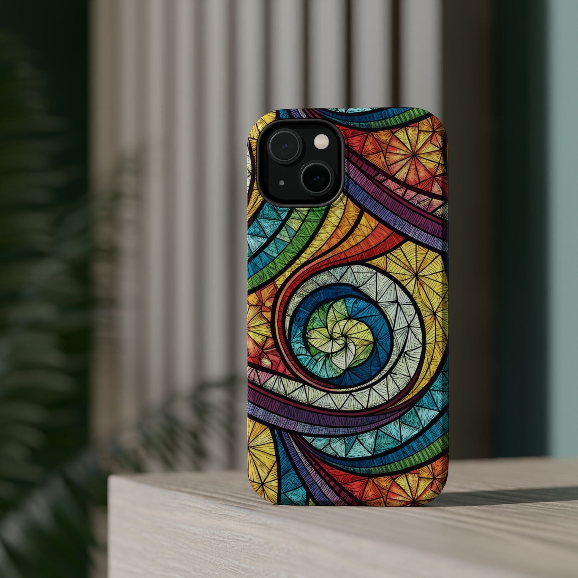 Stained glass inspired rainbow swirl iPhone case with vibrant protective design and built-in MagSafe magnet