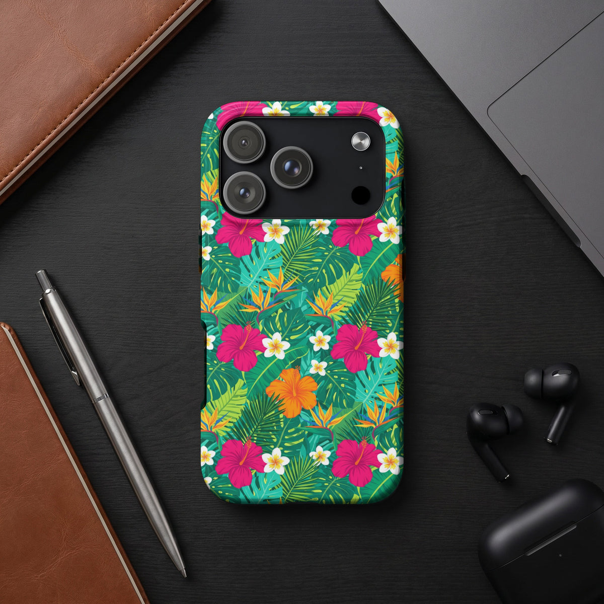 Phone case with a tropical floral pattern of hibiscus and palm leaves.
