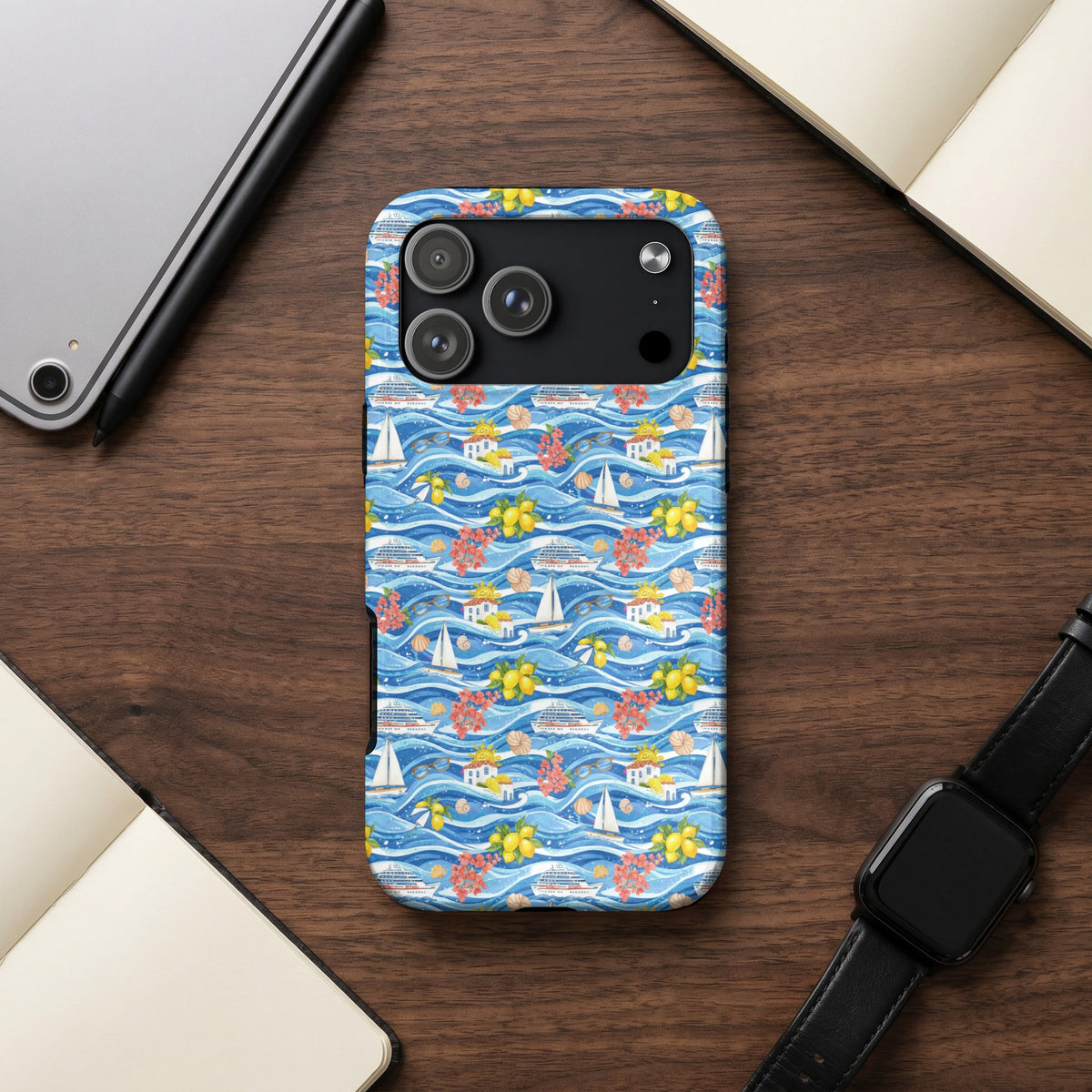 Phone case with a repeating pattern of sailboats, cruise ships, and lemons on blue waves.