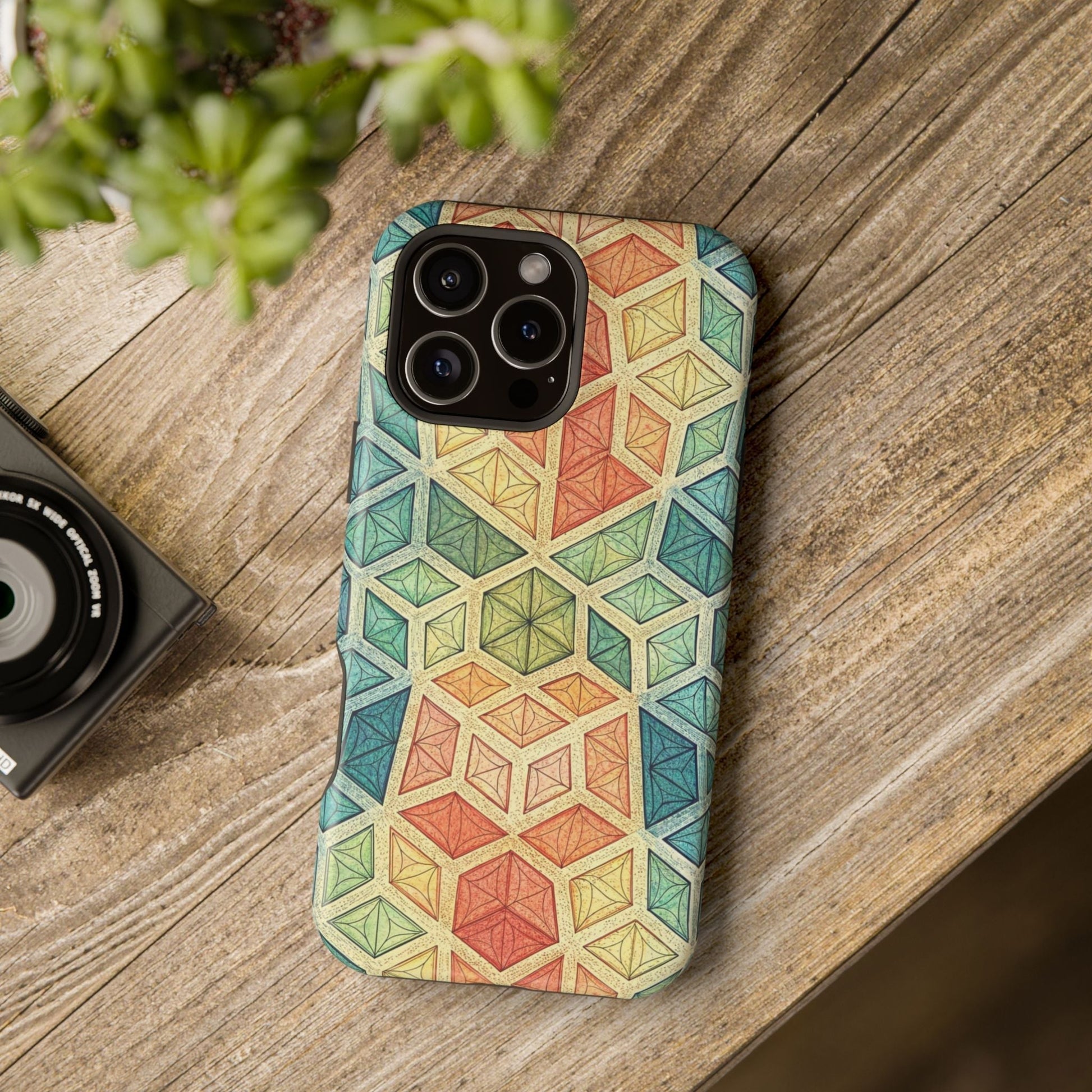 Colorful fractal geometric pattern iPhone magnetic tough case on wooden surface with camera nearby