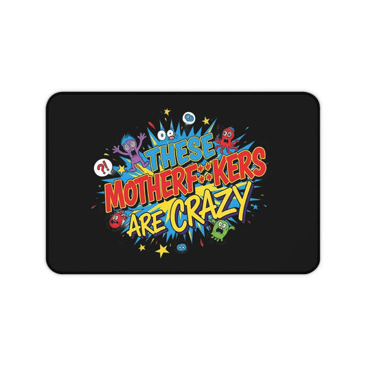 Funny black desk mat with colorful "These Motherf++kers Are Crazy" text and cartoon monsters, non-slip and durable neoprene office work mat
