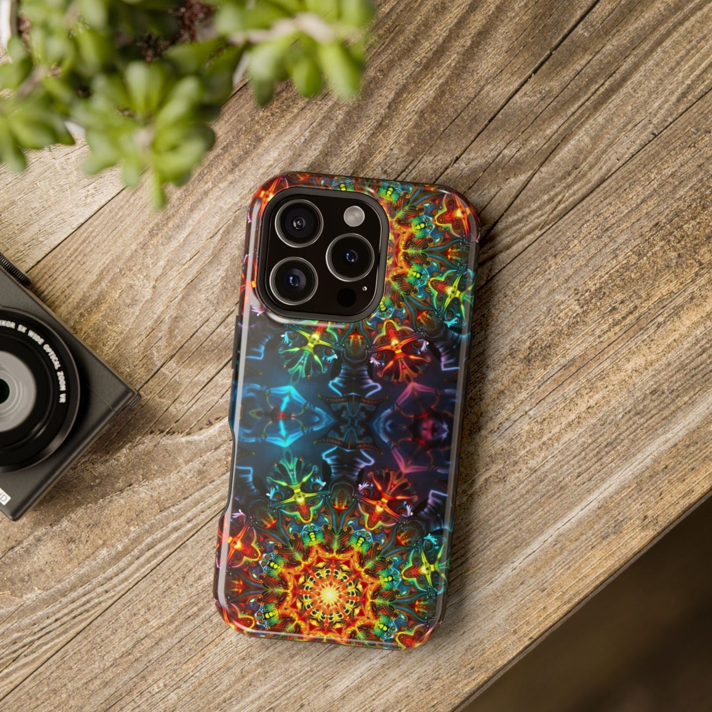 Colorful Abstract Kaleidoscope Design iPhone case with durable dual-layer protection and MagSafe compatibility on wooden surface