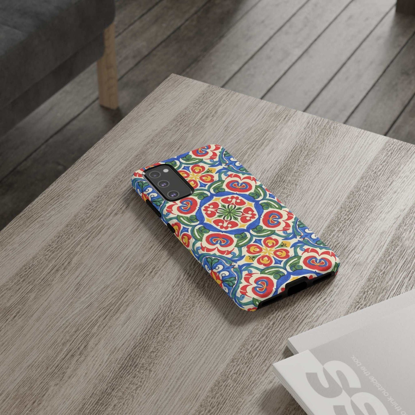 Mediterranean Samsung case with hand-painted folk tile pattern in bright blues, reds, and greens on a protective dual-layer phone cover