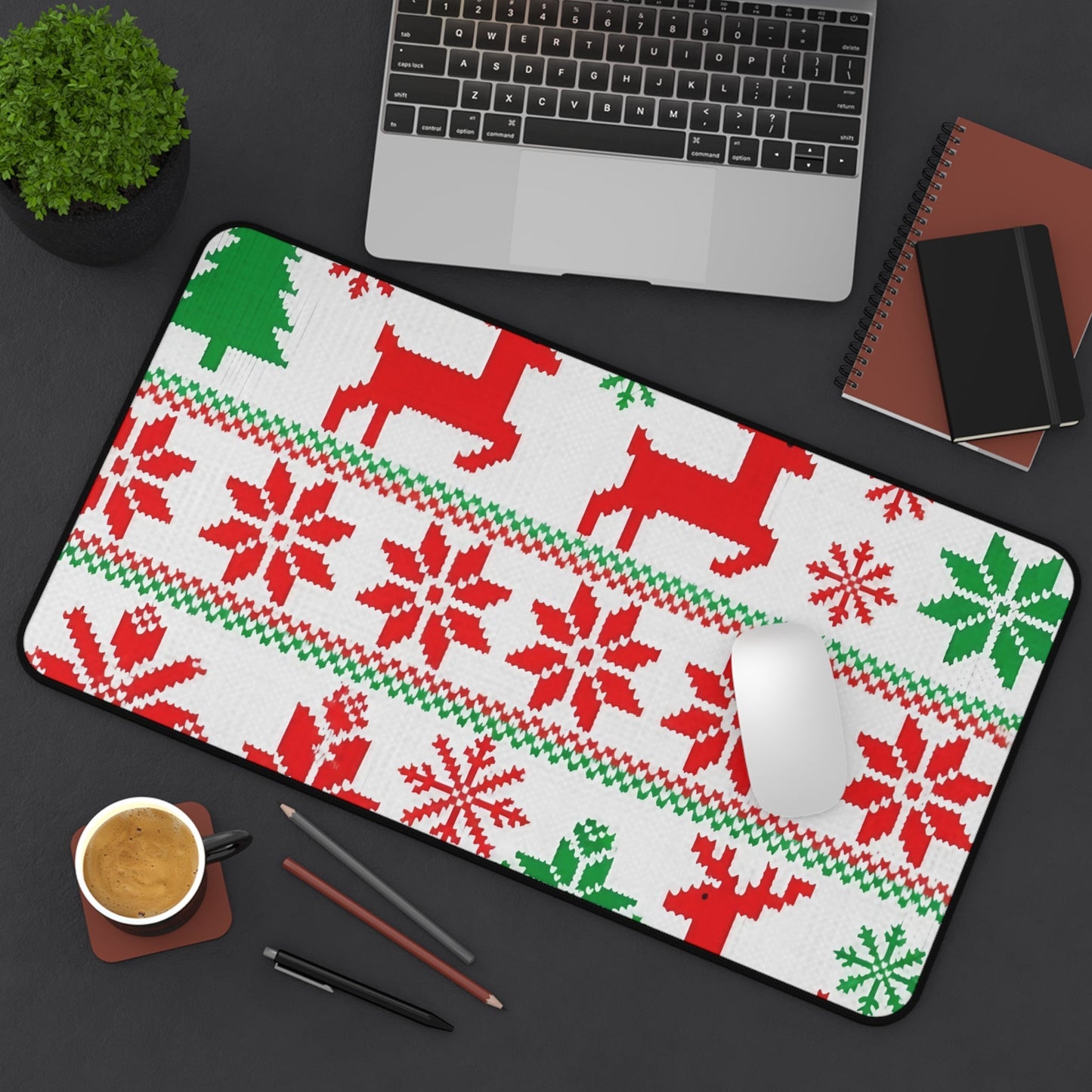 Ugly Sweater Inspired Desk Mat with festive red and green holiday patterns, non-slip bottom, and hemmed edges on workspace.