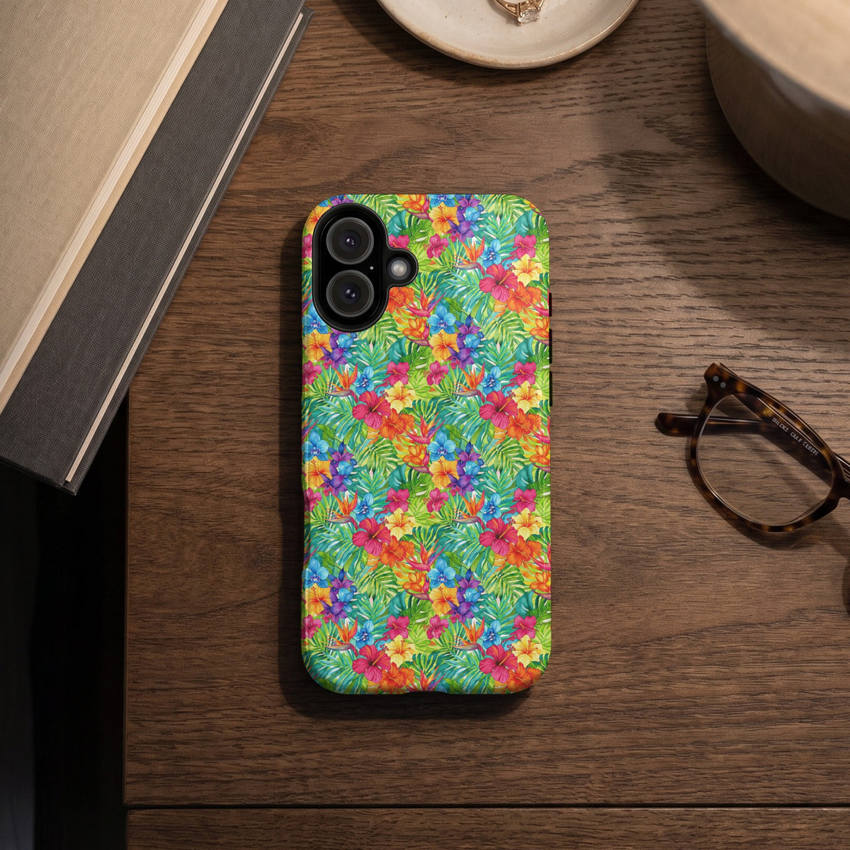 Phone case with a colorful tropical floral and leaf pattern.