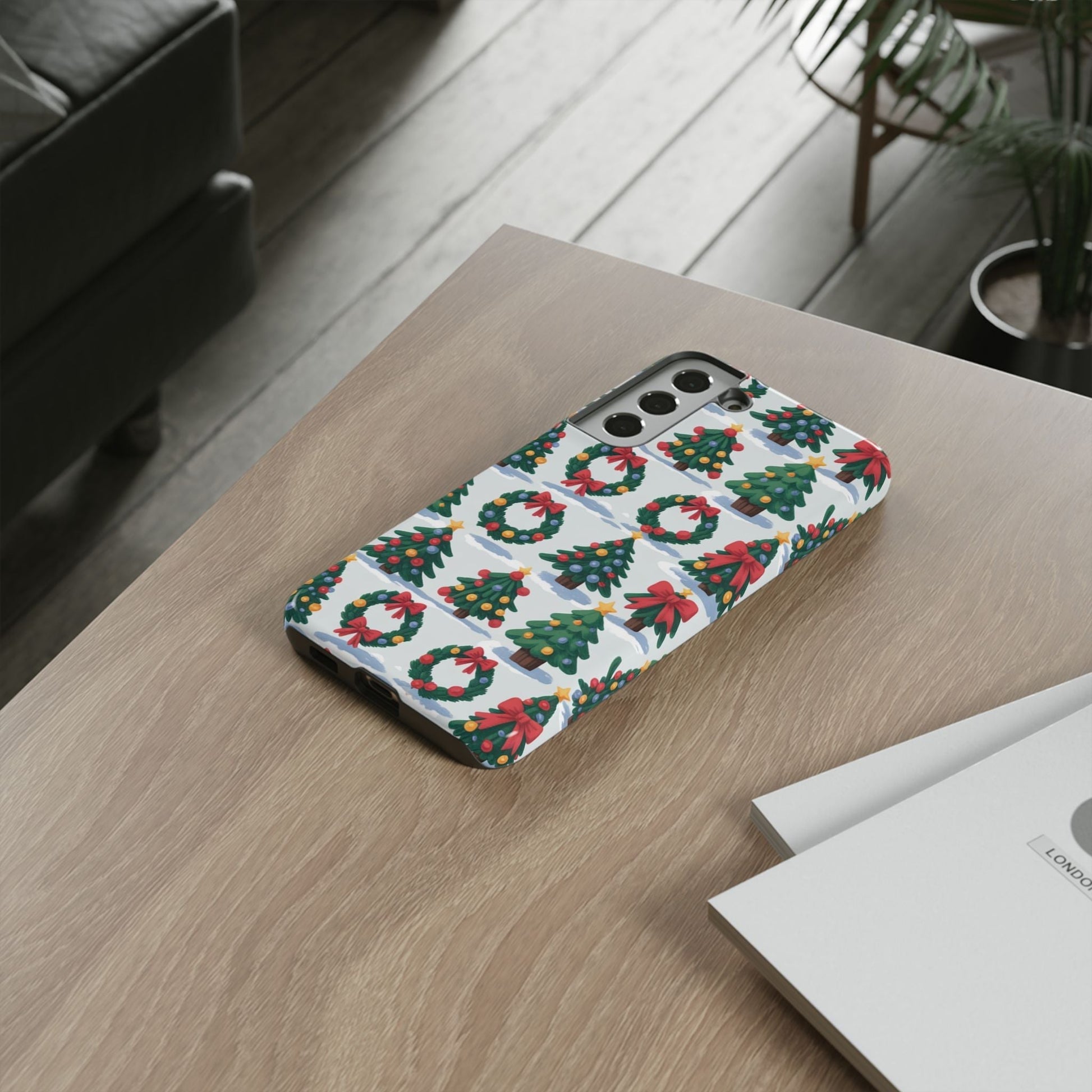 Samsung phone case with festive holiday wreath and Christmas tree pattern on a wooden table