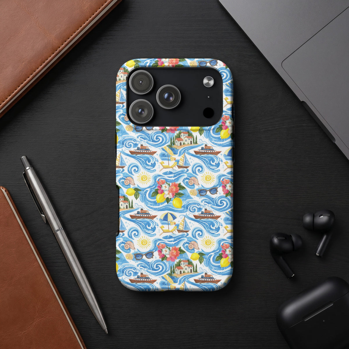Phone case with a blue and white nautical pattern featuring boats, houses, lemons, and flowers.