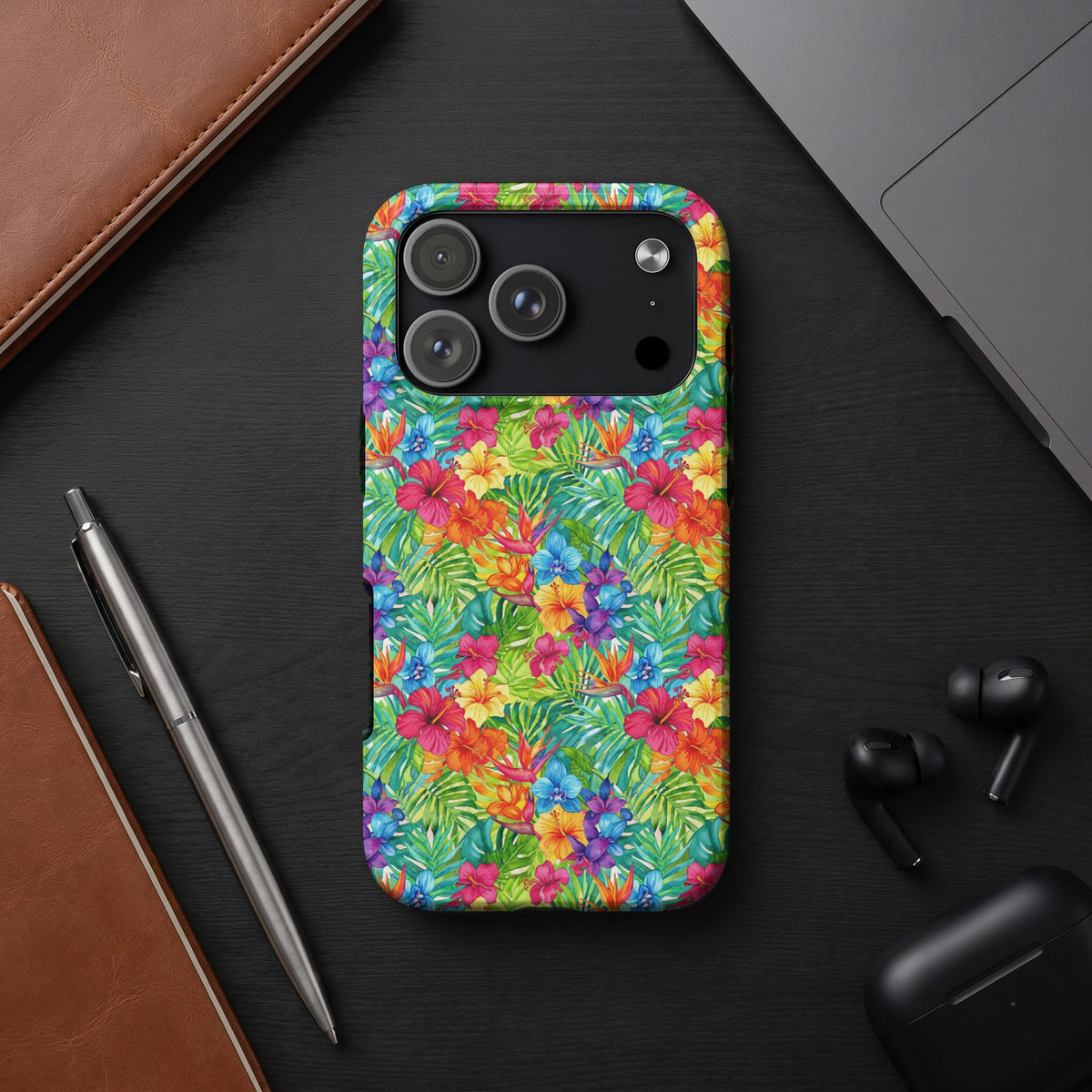 Colorful floral and leaf pattern phone case on a black surface.