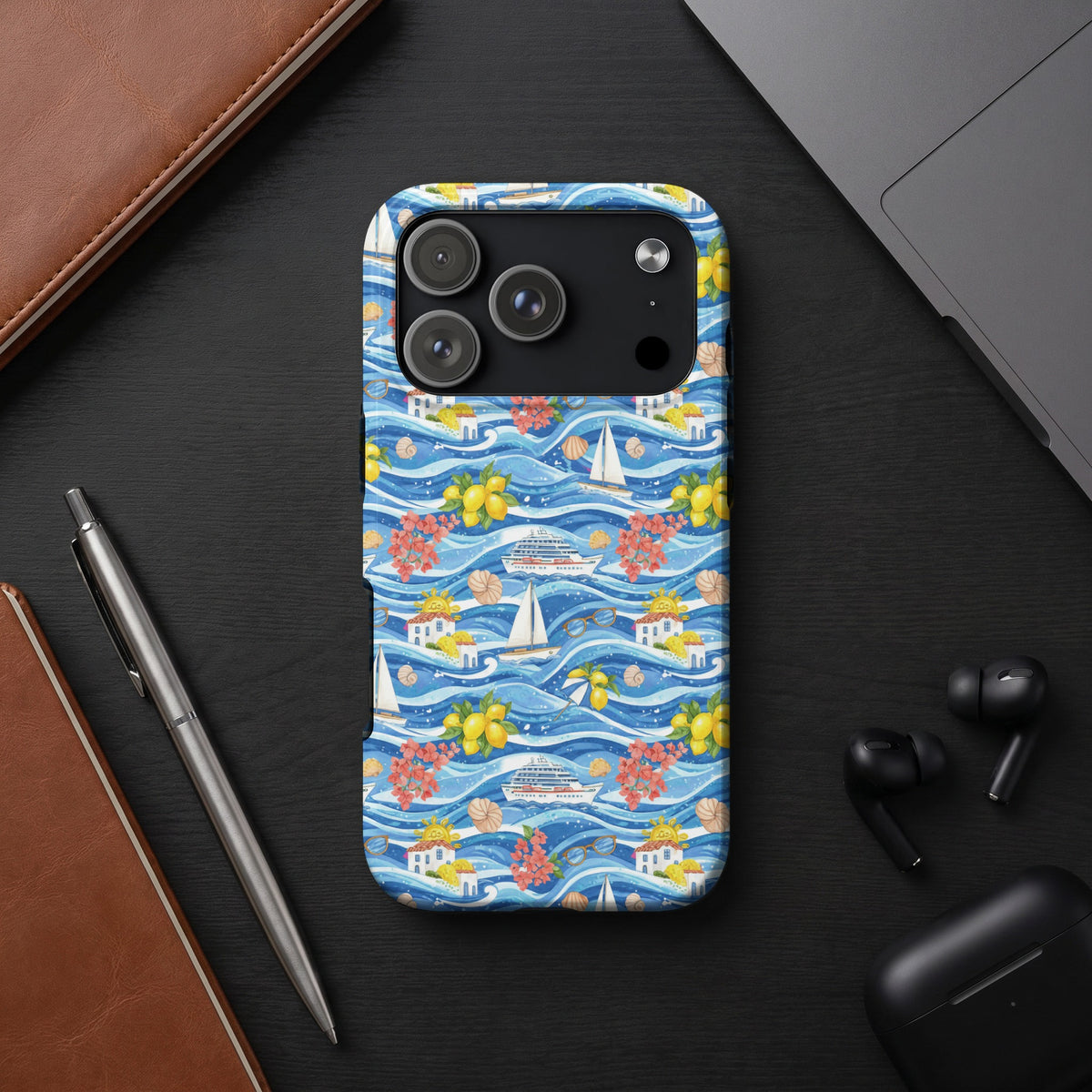 Phone case with blue wavy water, boats, cruise ship, lemons, flowers, and houses.