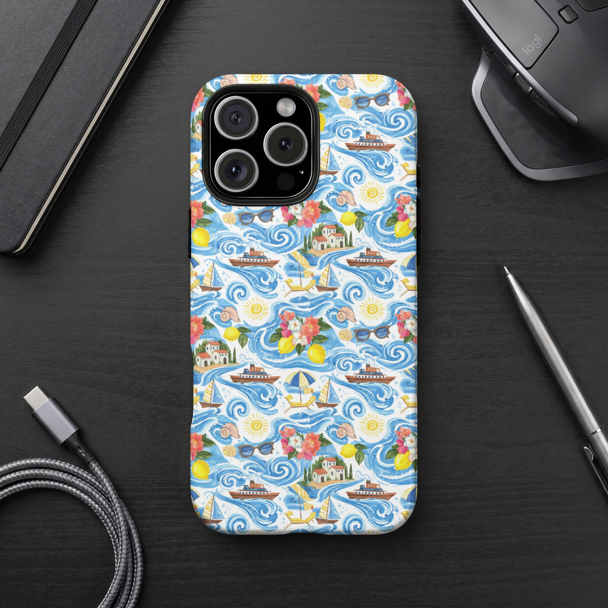 Phone case with a watercolor pattern of ships, sailboats, houses, and lemons on blue waves.