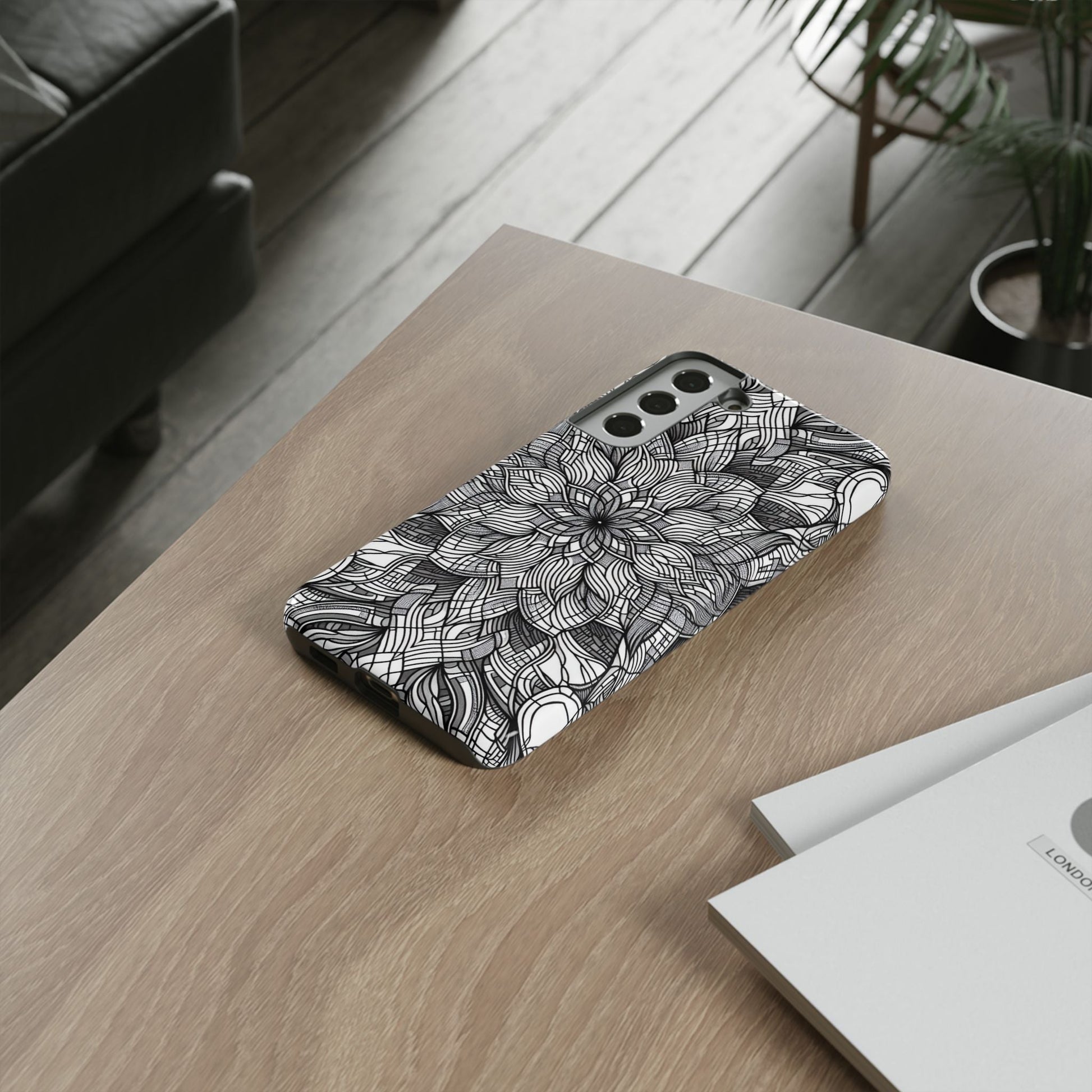 Black and White Art Explosion Samsung phone case with intricate floral design on wooden table