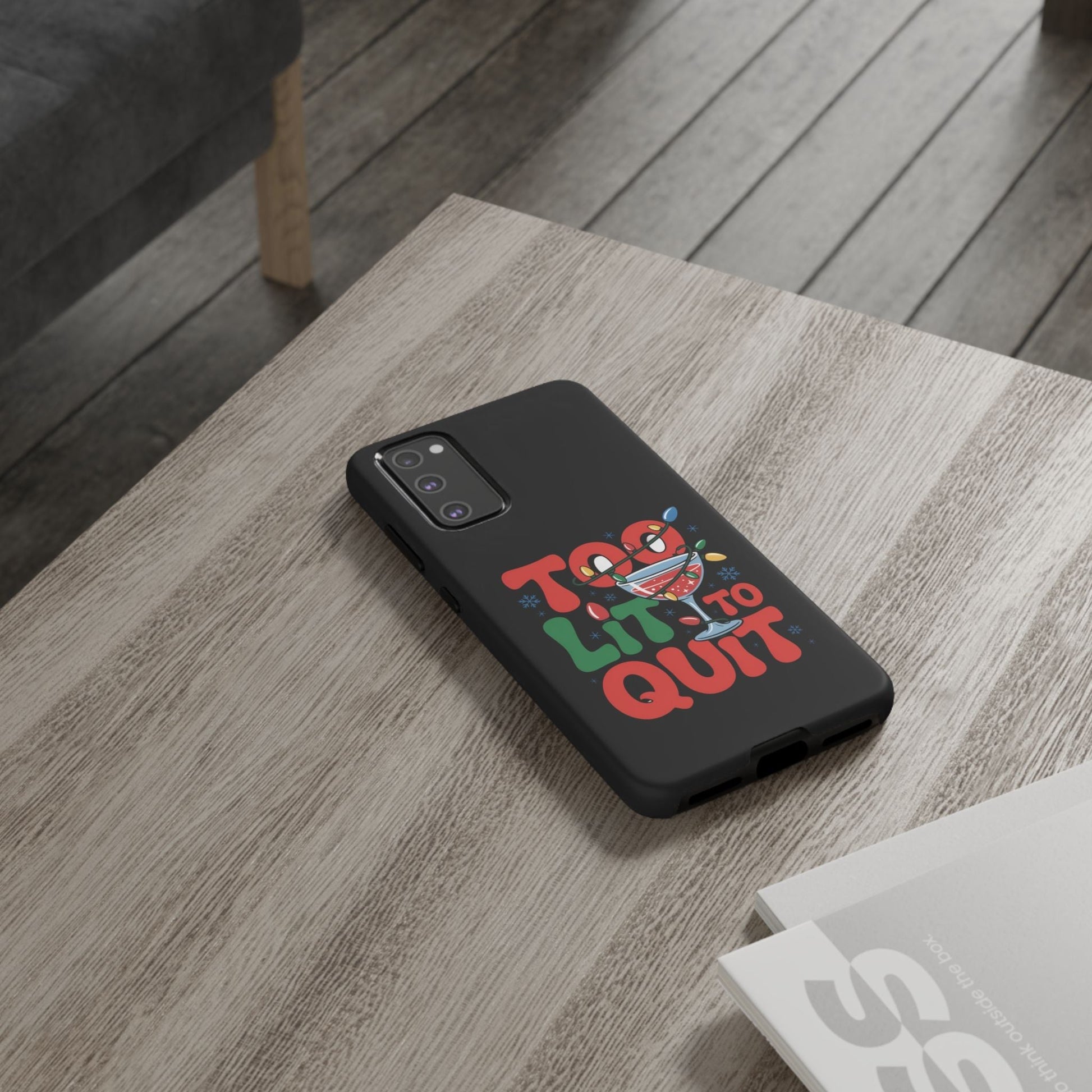 Holiday themed Samsung phone case with colorful festive "Too Lit to Quit" design on black protective cover