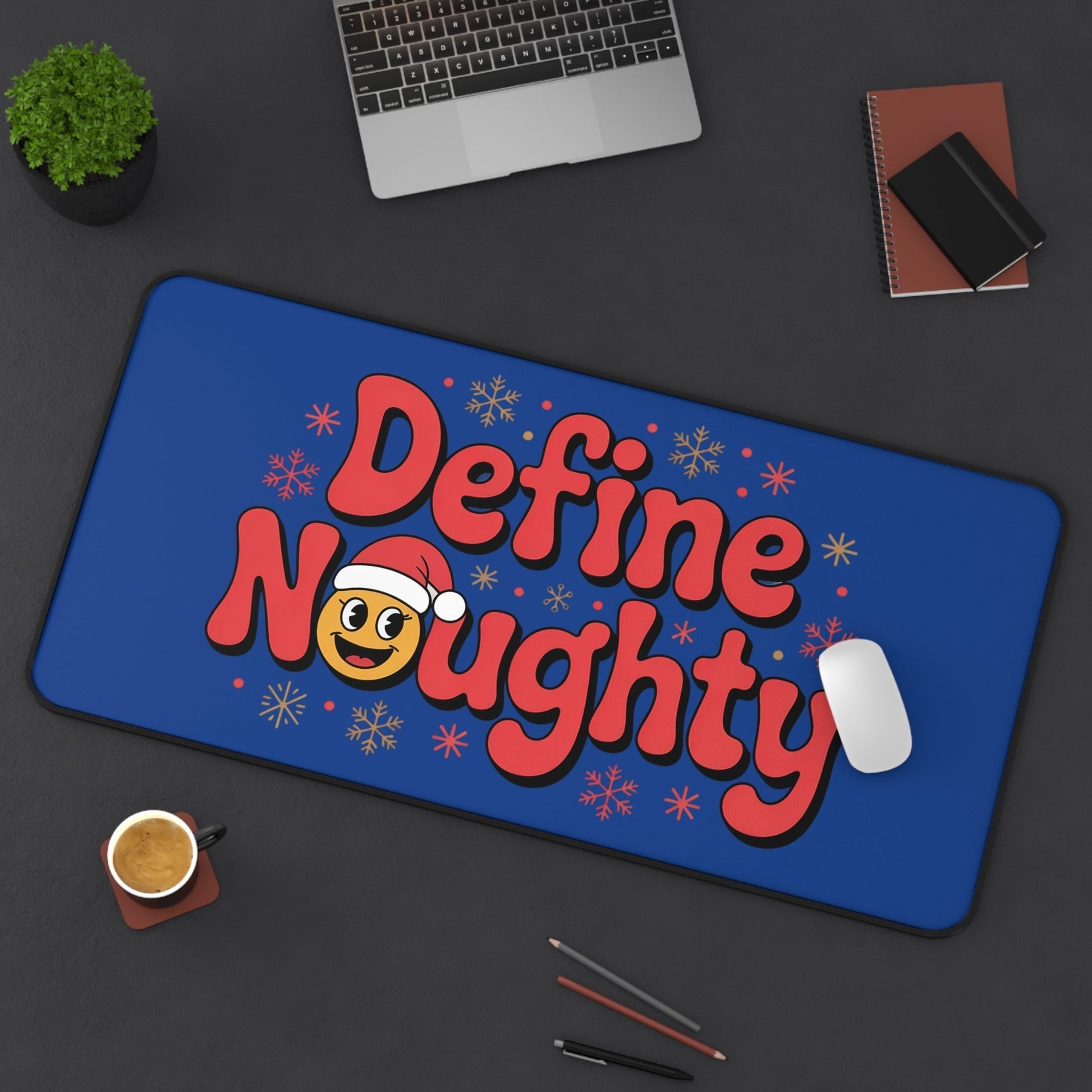 Define Naughty Desk Mat with playful text and Santa emoji on blue background, non-slip and durable surface for office or home use