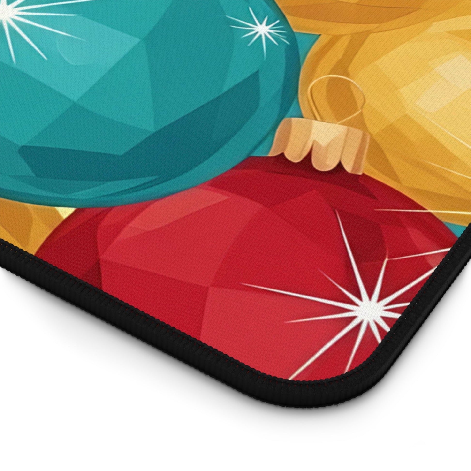 Close-up of holiday-themed desk mat featuring colorful Christmas tree bulb design with hemmed edges and non-slip bottom.