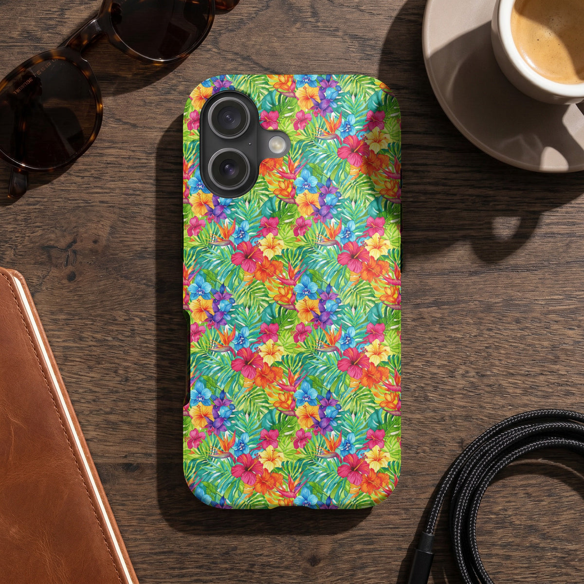 Phone case with a colorful tropical hibiscus and leaf pattern.