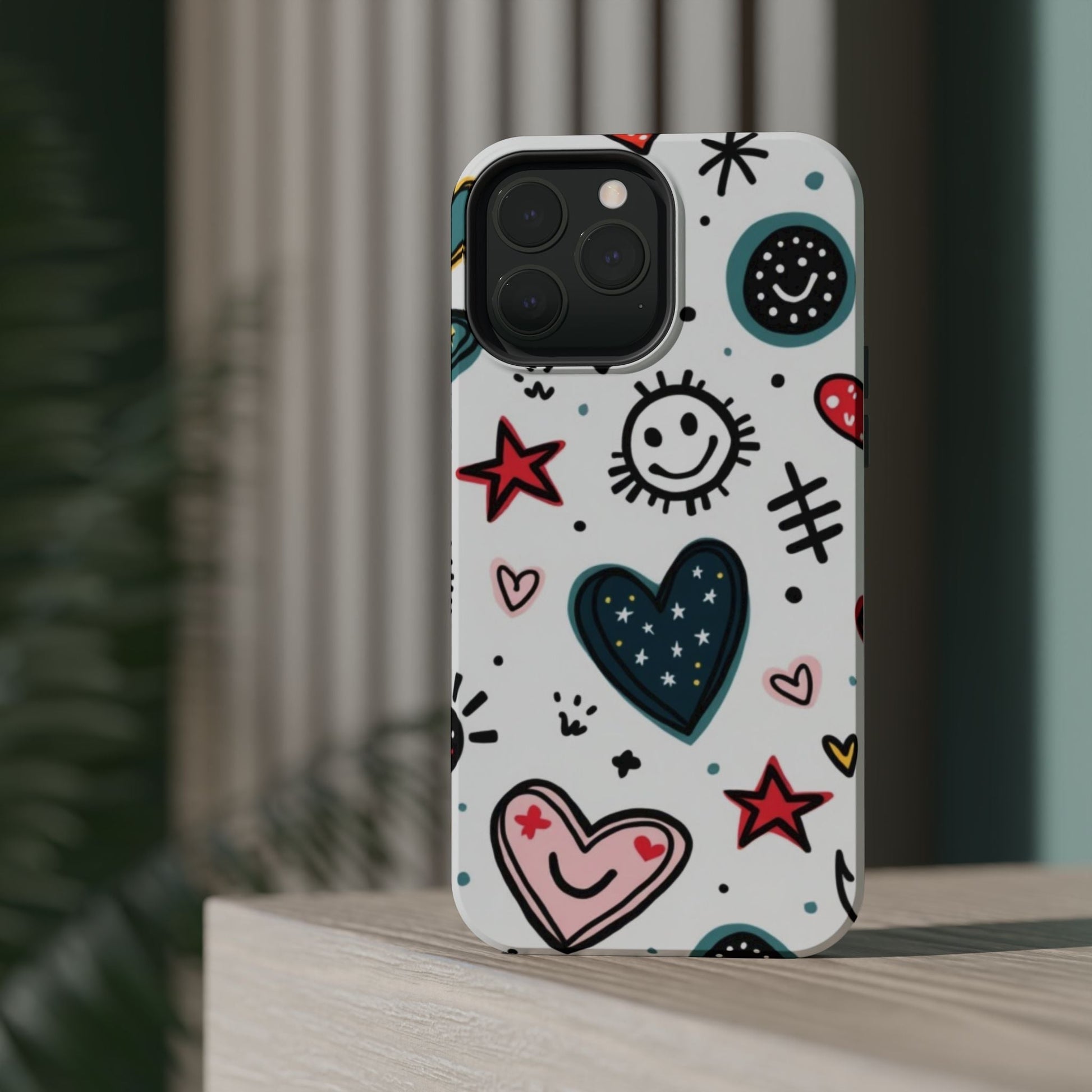 iPhone tough case with cartoon hearts, smiles, stars, and playful designs in vibrant colors