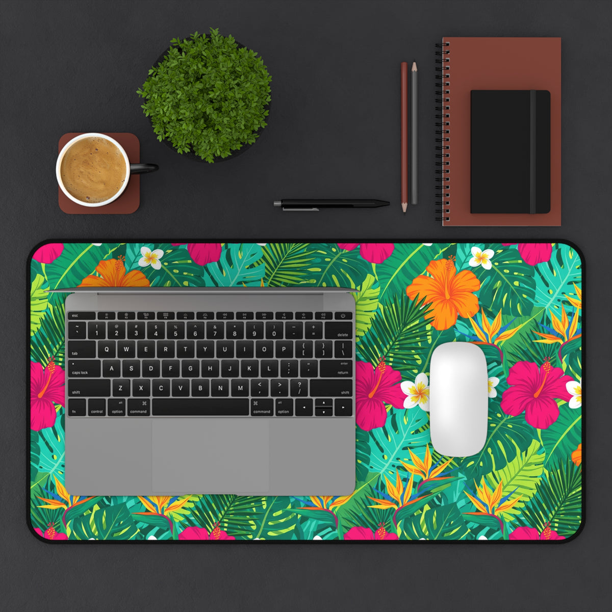 Large desk mat with tropical floral and leaf pattern featuring a laptop and mouse.