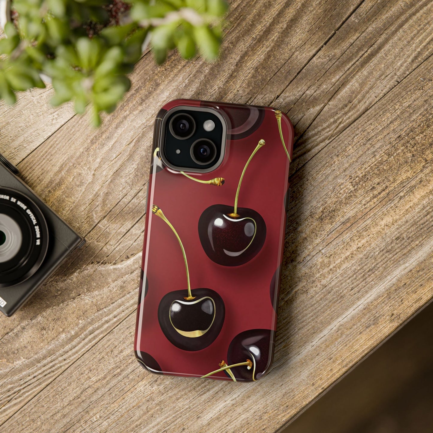 Cherry iPhone tough case with vibrant dual-layer cherry design and MagSafe compatibility on wooden surface