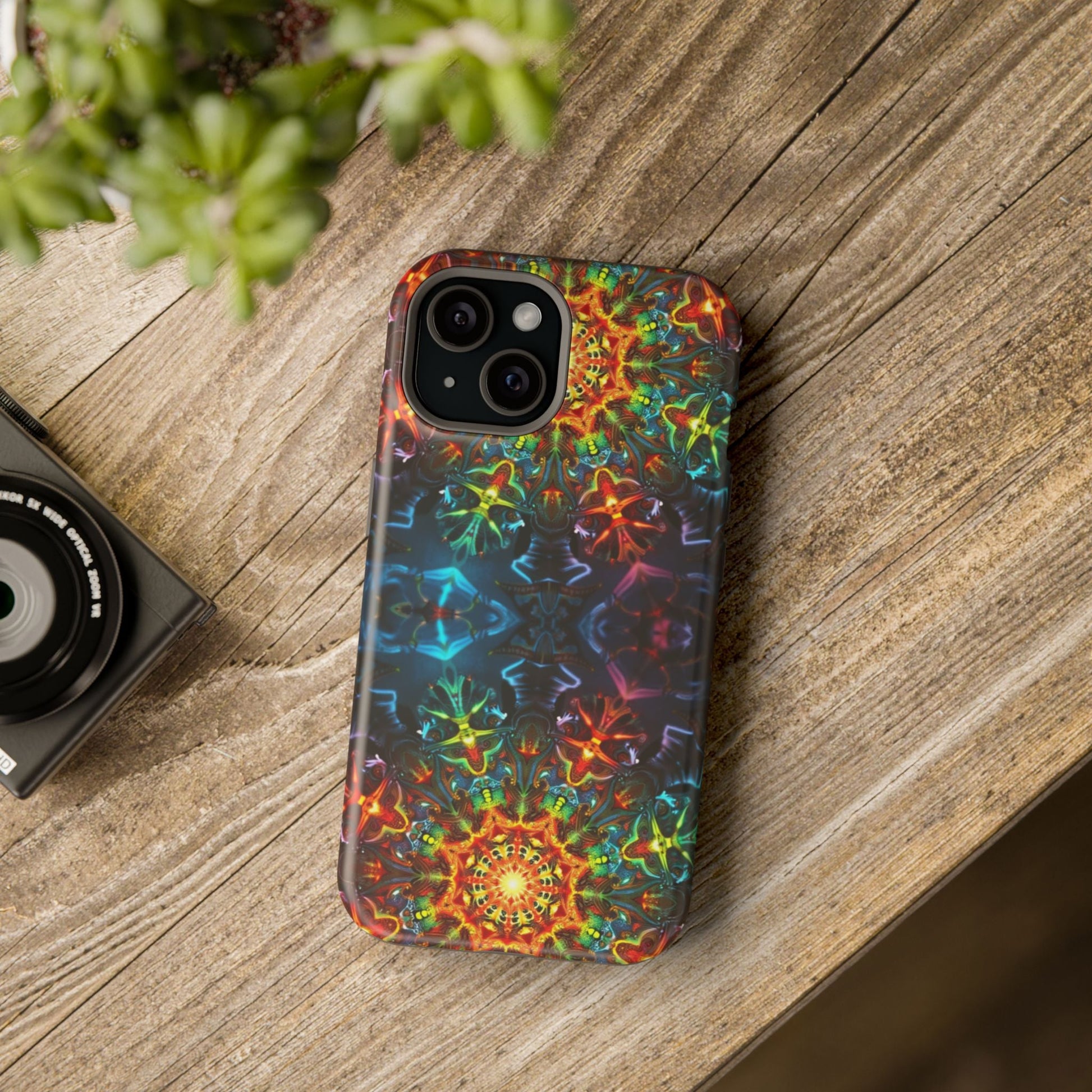 Colorful abstract kaleidoscope design iPhone case with durable dual-layer protection on wooden surface