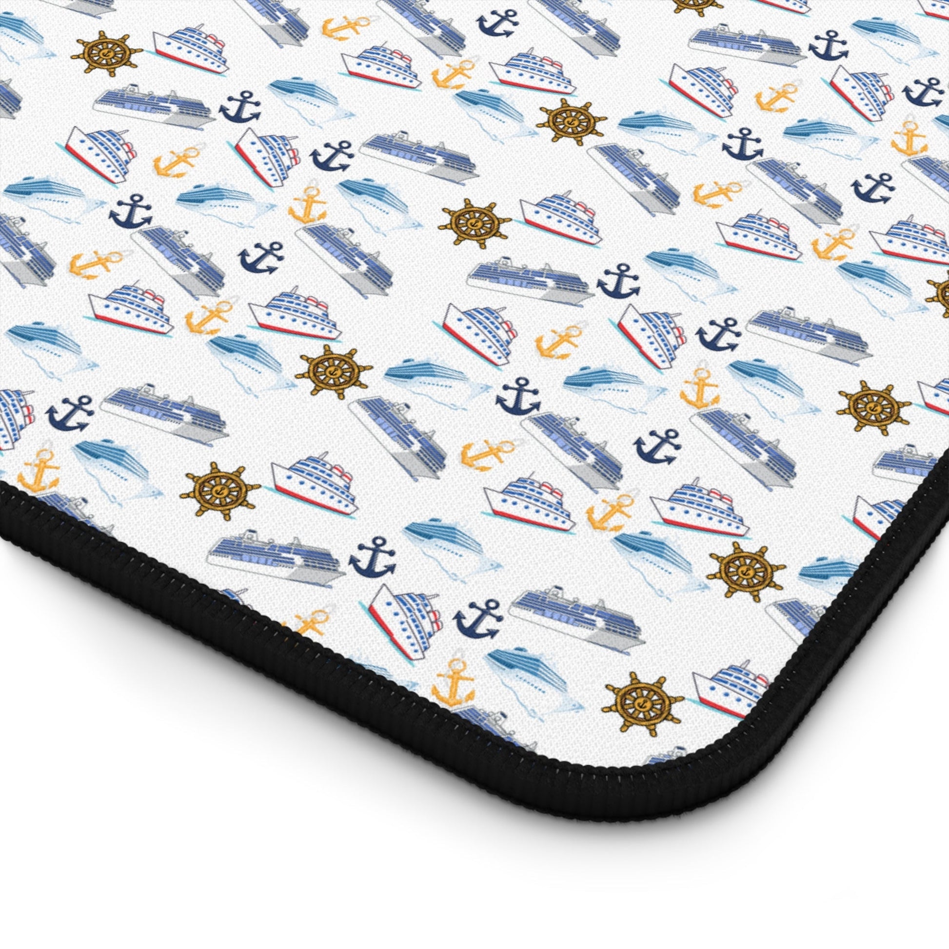 Cruise ship inspired desk mat with nautical-themed icons and black hemmed edges on white neoprene surface