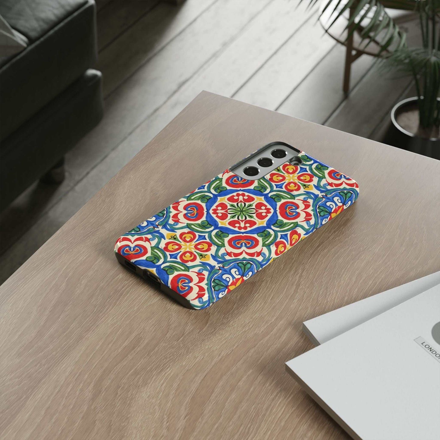 Mediterranean Samsung case with hand-painted folk tile pattern in vibrant blues, reds, and greens on a protective phone cover